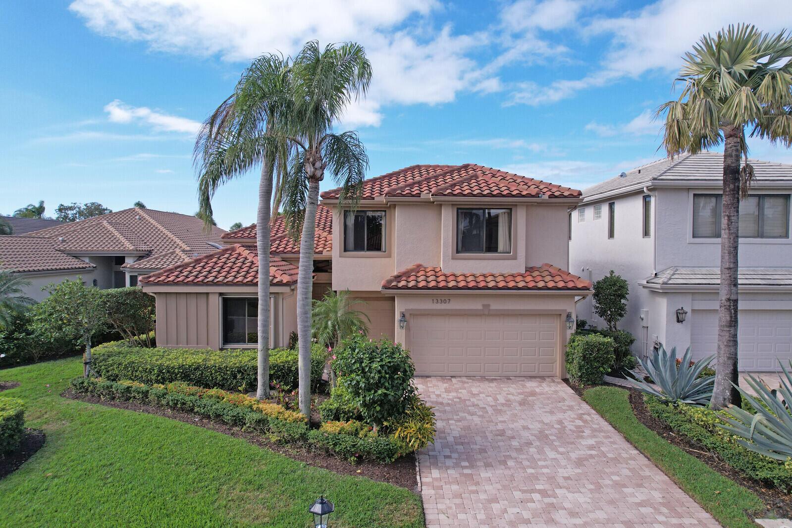 Stunning enlarged updated patio with screened in enclosure overlooking a large lake.