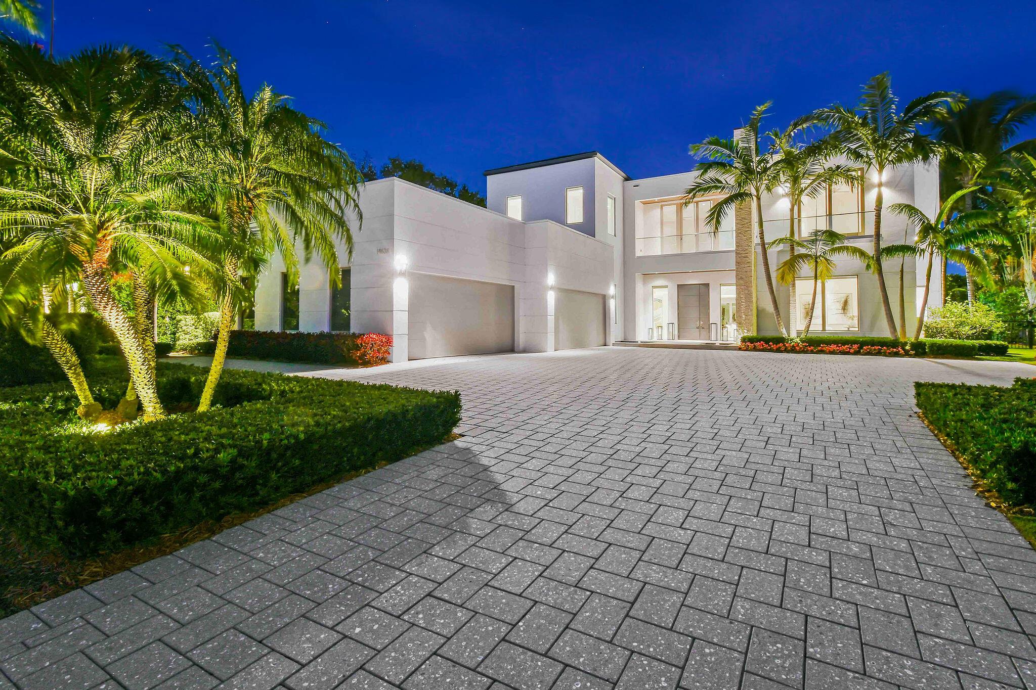 Nestled along the Intracoastal Waterway in the prestigious gated community of Harbor Place, this custom waterfront estate combines modern luxury with breathtaking views. Built by premier custom builder Couture Lifestyles Homes, this residence showcases expert craftsmanship with the highest level of detail and quality. Meticulously maintained at a level not often available. Situated on a generous 0.82-acre lot, the residence features 5 expansive bedrooms, 6 full bathrooms, and 3 half bathrooms, encompassing over 9,000 square feet of living space (10,000+ total). Its prime location provides direct water access, a private dock with a new 30,000 pound Hi-Tide lift, and a seamless connection to both land and sea. Constructed with reinforced CBS and tie-beam construction, extensive protection with 5000 psi poured concrete, and Andersen impact-resistant doors and windows, this home is built for durability. Interior highlights include large format custom marble and wood flooring, a gourmet kitchen with high-gloss lacquer cabinetry, marble countertops, Subzero and Wolf appliances, and a butler's kitchen. The first-floor primary suite features a private, individual, his-and-her bathrooms with Italian styled closets. The additional primary suite located on the 2nd floor offers incredible views from an elevated perspective. The Gym/Spa room is illuminated by natural light from the skylights, creating a serene retreat. 
Outdoor living spaces are equally impressive, with 2 pools, a lap pool and additional 2nd floor spool pool with infinity edge, both offering panoramic views of the intracoastal waterway. Nicely appointed summer kitchen, with dining area. Smart home features include Lutron lighting, automated shades, a 4K 10MP camera system with Digital Watchdog Cloud recording and a remote controlled, high performance, Coastal Source exterior audio system. 
The meticulously landscaped grounds include a private beach, meditation Labyrinth, nightscape lighting, irrigation system, waterfront IPE deck lounging area, and luxury-grade anti-microbial synthetic turf. A whole house 70 KW generator, elevator and an oversized air-conditioned 4-car garage enhance functionality. 
The Club Room is an entertainer's dream, featuring two Subzero wine coolers with a 500-bottle capacity, multiple TV access points for simultaneous viewing for sports enthusiasts, a sophisticated bar and an arcade/gaming alcove. Designed by luxury interior designer Pauline Hartogh, the home features a sleek, modern aesthetic with Porcelanosa designer tiles and Alex Turco built-in art. The property also benefits from a lower tax rate because it is classified as county-only, exempting it from city taxes. With expansive outdoor living areas this estate is a harmonious blend of elegance, innovation, and location. It's the quintessential Florida waterfront lifestyle. Welcome to your private oasis at 14638 Watermark Way, where luxury living meets timeless design.