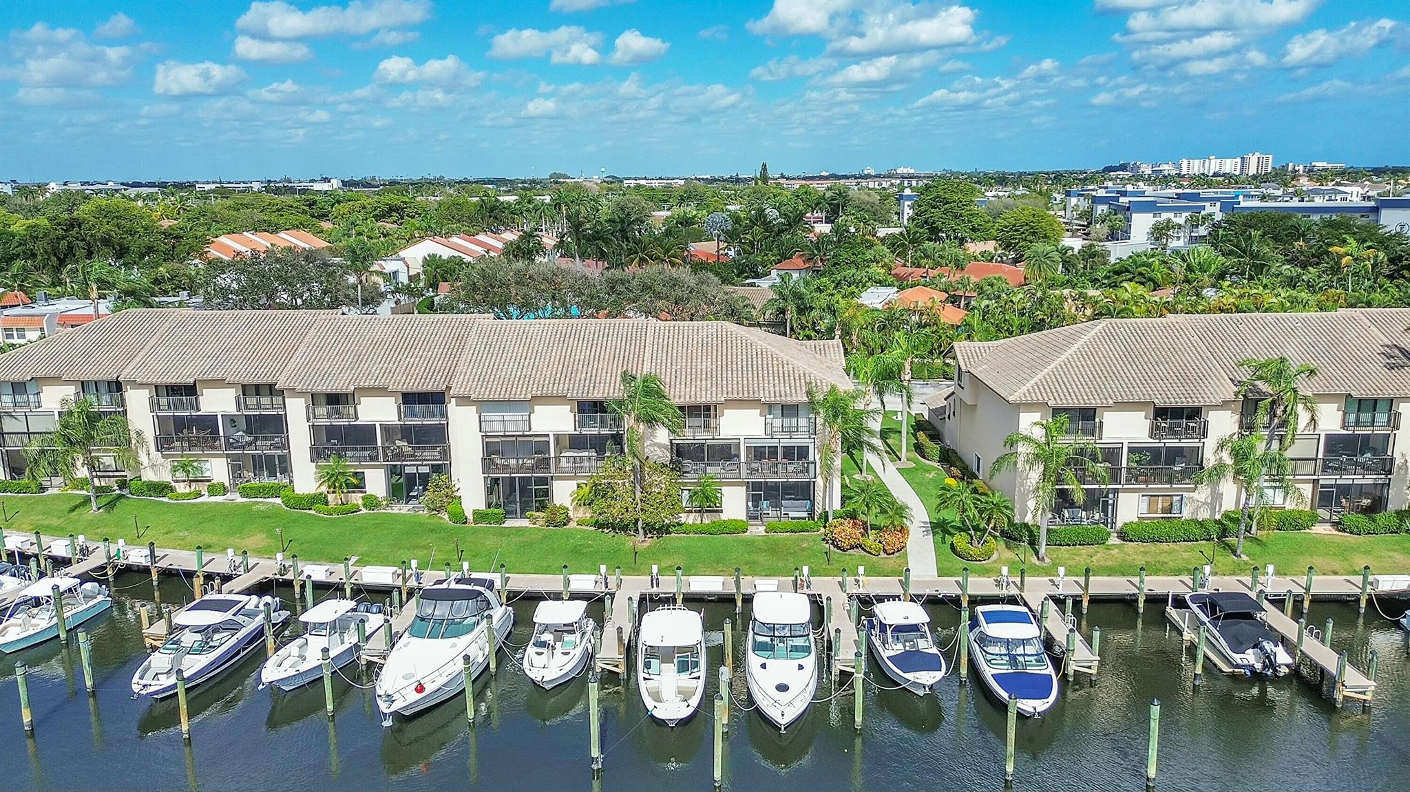 Step into waterfront luxury living in Pelican Harbor's Captain's Walk with this rarely available, fully remodeled 3-bedroom, 2-bathroom first-floor corner condo. Completely turnkey and thoughtfully designed with luxury furnishings, this unit offers plush new beds, smart TVs, and an open-concept living and dining area that flows to an enclosed, screened patio with stunning views of the docks and the C-15 Canal extending to the Intracoastal Waterway. The chef-inspired kitchen features sleek cabinetry, quartz countertops, and a wine fridge, while additional highlights include an in-unit washer/dryer, complete hurricane impact windows and doors, and elegant, modern upgrades throughout. Located in the highly desirable, 24-hour gated community of Pelican Harbor, residents enjoy access to resort-style amenities, including a clubhouse, two heated pools, a gym, lighted tennis and pickleball courts, and a marina. Ideally situated between Downtown Delray's Atlantic Avenue and Downtown Boca Raton's Mizner Park, this property offers the best of South Florida living. Rental options: $7,000/month annually turnkey (fully furnished), $6,000/month annually unfurnished, or $10,000/month seasonally through 4/30/2025. Cable, internet, and all HOA amenities are included. Don't miss the opportunity to make this waterfront oasis your home!