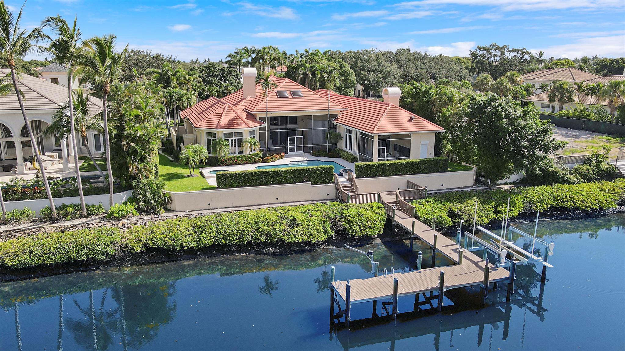 Discover a rare chance to own a deep-water property in the exclusive gated community of Admirals Cove. This unique offering is one of a select few estates where club membership is optional, granting you flexibility to tailor your lifestyle. The home is brimming with potential, presenting an excellent opportunity for value-enhancing renovations while utilizing the existing functional floor plan. Admirals Cove, renowned as a premier country club community, boasting world-class amenities including championship golf, tennis facilities, and an impressive clubhouse. Embrace the South Florida lifestyle with your own deep-water dock, perfect for housing boats and water toys. Don't miss this chance to create your dream home in one of the most sought-after communities in the region.