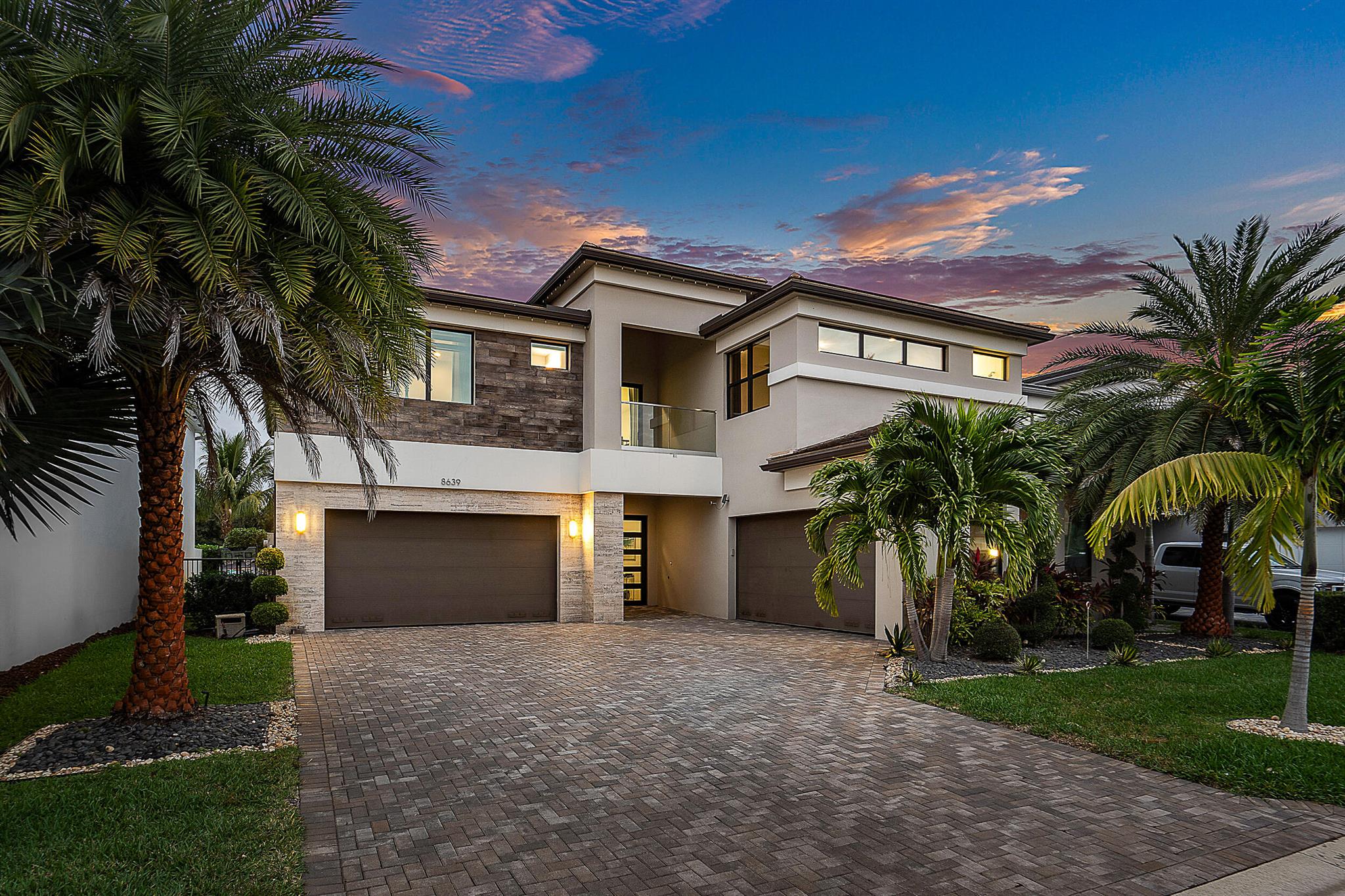 2.5% assumable mortgage! Welcome to your dream home in the prestigious Lotus community and discover modern luxury in the heart of Boca Raton! This contemporary pool home showcases over $100K in custom upgrades, combining modern elegance with unmatched comfort. From the moment you approach the striking, custom-made front door, you'll be captivated by the home's sophisticated style and attention to detail. Inside, sleek modern finishes, designer lighting and custom electric window treatments create an ambiance of luxury and convenience. The home boasts two spacious 2-car garages with epoxy-sealed floors, perfect for housing your luxury vehicles, toys or extra storage. Step outside to your private pool oasis, ideal for entertaining or simply unwinding after a long day. Homes on this side of the street have 20 more feet of open backyard space to enjoy, as well as a serene view of nature. You can be sure to spot a variety of birds and other wildlife on any given day from your fenced yard. No view of other homes across the way from this lovely location! The gated, guarded community of Lotus offers world-class amenities designed for an active and luxurious lifestyle. The state-of-the-art clubhouse features resort-style pools and lounges, indoor and outdoor basketball courts, fitness center with top-tier equipment, tennis and pickleball courts, kids' playroom and covered playground, game room, full-menu restaurant and so much more! Every aspect of this home and community has been designed to elevate your lifestyle. Each month, the Lotus lifestyle Director sends out the monthly itinerary of creative events for families, kids and adults, bringing in outside entertainers, trainers and practitioners, making it a fun and memorable experience for everyone. The sense of community is unmatched here! Be sure to tour the clubhouse and experience the Lotus difference - it's more than a home, it's a lifestyle. Schedule your private showing today!