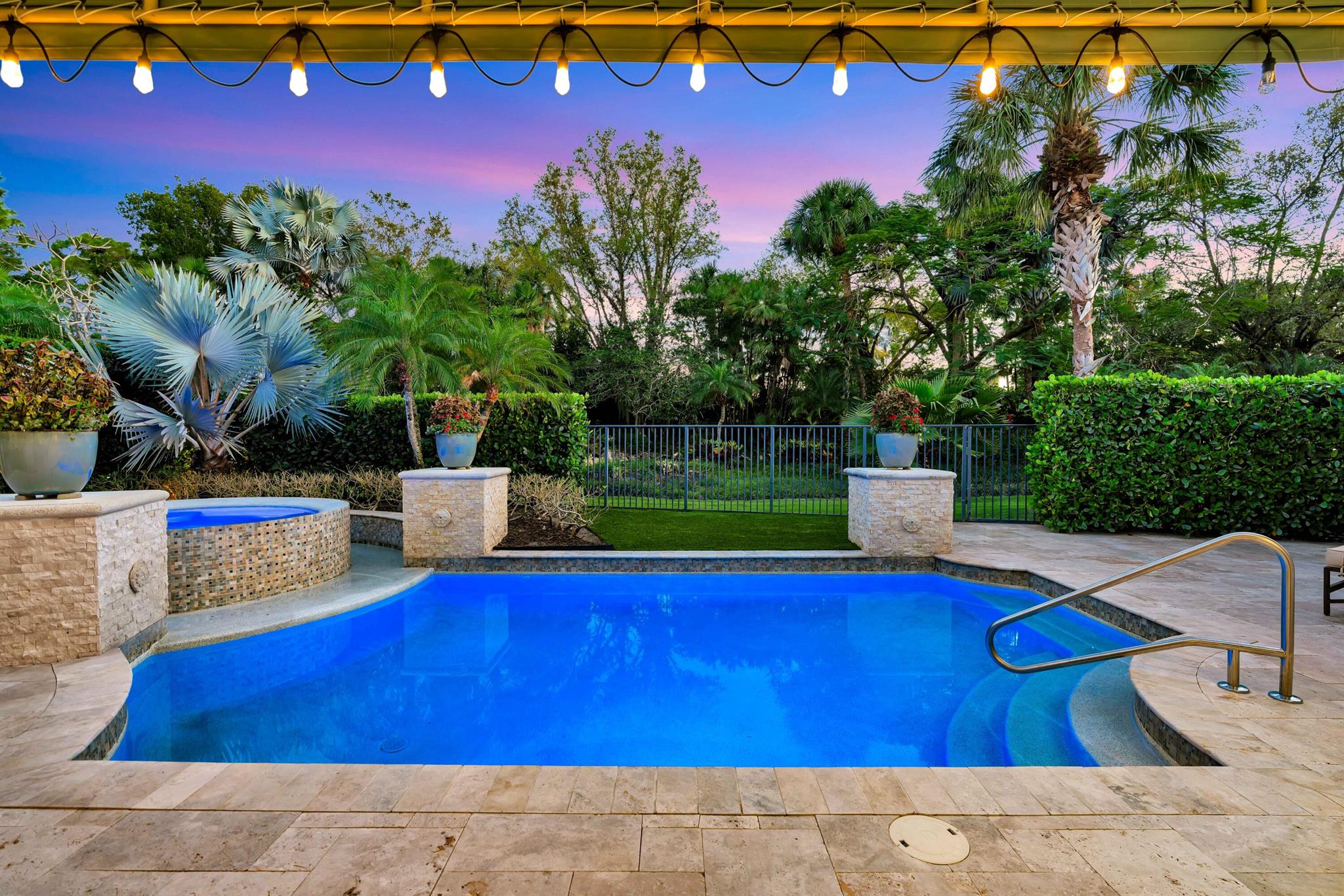 Welcome to 11216 Orange Hibiscus Lane, a meticulously updated and fully furnished residence with a NEW ROOF in the prestigious Old Palm Golf Club. This elegant home offers 4 bedrooms, 4 full bathrooms, and 2 half bathrooms within 3,735 square feet of living space. &#65532;Upon entering, you're greeted by a spacious great room featuring a newer built bar, ideal for entertaining guests. The open floor plan seamlessly connects the great room to a gourmet kitchen equipped with white cabinetry, quartz countertops, a large island, and newer appliances. Adjacent to the kitchen is a sunny breakfast room, perfect for casual dining. &#65532;The primary suite is a private retreat, boasting two walk-in closets, dual vanities, a luxurious tub, and a separate shower. A cozy office/den provides a quiet space for work or relaxation, while a long hallway leads to three additional en suite guest bedrooms, ensuring comfort and privacy for all residents. Step outside to the beautifully landscaped patio and pool area, where you can enjoy Florida's year-round sunshine. The property overlooks a decorative water feature maintained by the association, enhancing the serene ambiance. As a resident of Old Palm Golf Club, you'll have access to a new 20,000 square-foot lifestyle center featuring a fitness facility, spa, lap pool, and more. Please note that membership is required to enjoy these exclusive amenities. This exceptional property combines luxury, comfort, and an enviable location, offering a unique opportunity to experience the finest in South Florida living.
