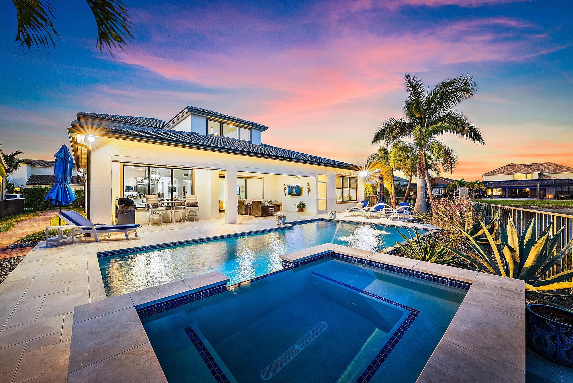 Welcome to a home where every detail has been thoughtfully crafted to inspire energy, relaxation, and luxury. Nestled in the heart of Sonoma Isles, Jupiter's premier gated and family-friendly community, this exquisite property offers a harmonious blend of modern design and timeless elegance.As you step inside, you'll be greeted by an open and airy floor plan that seamlessly connects the living spaces. This meticulously maintained Garden Vista model boasts four bedrooms, four and a half baths, an office, and a spacious loft. The home is perfectly situated on a tranquil lakefront lot, providing breathtaking views that enhance the sense of serenity. Custom woodwork throughout adds a touch of warmth and character, complementing the tile flooring downstairs and the rich wood flooring upstairs.

The heart of this home is the stunning chef's kitchen, where culinary dreams come to life. Equipped with top-of-the-line stainless steel appliances, white cabinetry, a tasteful backsplash, and an expansive eat-in island adorned with a modern farmhouse chandelier, this kitchen is both beautiful and functional. The design flows effortlessly into a generous great room with soaring ceilings and corner sliding glass doors, inviting the outdoors in and extending the living space onto the covered lanai. A nearby dining area, featuring exquisite wood-inlaid ceilings, creates the perfect setting for family meals or intimate gatherings.

The split floor plan ensures privacy and comfort, with the luxurious primary suite conveniently located on the main floor. Wake up to picturesque lake views in the serene sitting area, accented by shiplap walls and dual custom walk-in closets. The spa-like primary bath, with its oversized walk-in shower, is a retreat in itself. Upstairs, a spacious loft and two additional bedrooms provide plenty of room for family or guests.

Step outside, and you'll find a haven for relaxation and entertainment. Zero-corner sliding doors open to a lanai with electric screens, seamlessly blending indoor and outdoor living. Beyond lies a saltwater gas-heated pool surrounded by a stunning marble deck, all set on a sprawling .4-acre corner lake lot that feels like a private island. The lush lawn provides ample space for children and pets to play, creating a true backyard paradise.

Living in Sonoma Isles means access to exceptional community amenities, including a grand clubhouse, tennis and pickleball courts, a state-of-the-art fitness center, pool, spa, fire pit, and a clubhouse for private events. Located close to world-class restaurants, shopping, beautiful beaches, and Palm Beach International Airport, this home offers an unparalleled lifestyle.

Schedule your private tour today and experience the perfect combination of elegance, comfort, and convenience in this one-of-a-kind property. Welcome home.