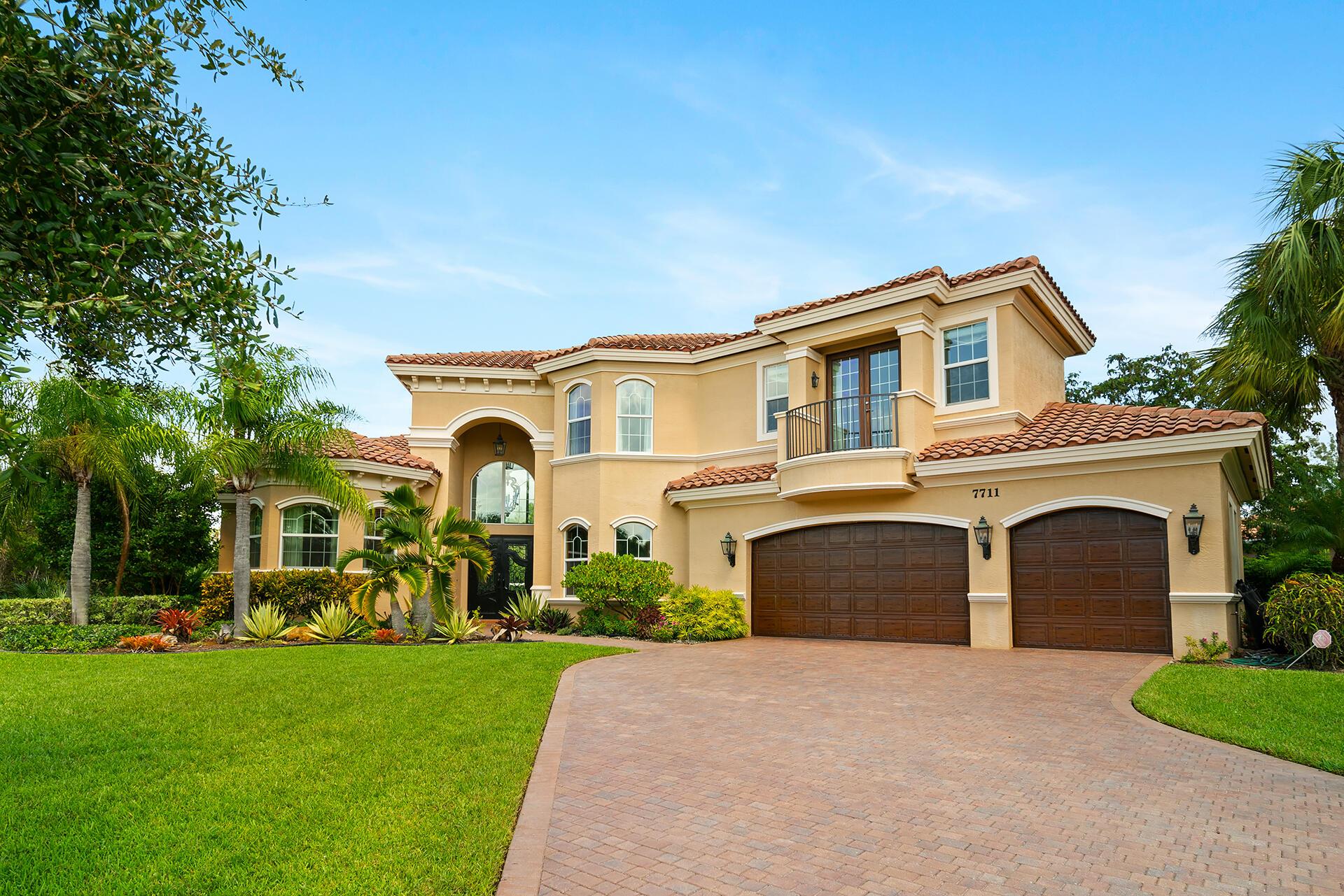 PRICE IMPROVEMENT! MUST SEE! Stunning, grand home. End Lot offering complete privacy with Preserve behind and on the side. The Lot is over a half acre and with the Preserve does not feel anything like typical development lots in Palm Beach Gardens. This stunning 5-bedroom, 7.1-bathroom residence offers unparalleled elegance and comfort in one of South Florida's most sought-after gated communities.  Option to join the PGA Reserve Golf Course within the community. This home boasts over 5,500 square feet of well-designed living space. The living room features a dramatic two-story ceiling with a stunning custom fireplace. The chef's kitchen is a culinary masterpiece with high-end stainless-steel appliances, backlit granite island, and loads of counter space for meal preparation and casual dining. Enjoy seamless indoor-outdoor living with a grand family room that opens to the beautifully landscaped backyard. The inviting covered patio and expansive pool area provide the perfect setting for relaxation and entertaining.
A separate dinning and wet bar are right around the corner. The main floor also features a graciously scaled office that exudes sophistication, featuring rich wood trim throughout. There is a media room with gorgeous bay windows and a guest suite leading out the pool.
Upstairs the spacious master suite is a true retreat, complete with a private sitting area, large walk-in closets, and a spa-like hers en-suite bathroom with a soaking tub, walk-in shower, and dual vanities. This exceptional home boasts two versatile lofts upstairs, offering unique spaces for relaxation, creativity, or productivity. Additionally, there are two more generous sized bedrooms upstairs.
Throughout the home, you'll find high-quality finishes including hardwood and tile flooring, crown molding, and designer lighting fixtures that enhance the overall aesthetic. This exceptional home is more than just a residence; it's a lifestyle. Experience the perfect blend of luxury, comfort, and community in this extraordinary Palm Beach Gardens property.