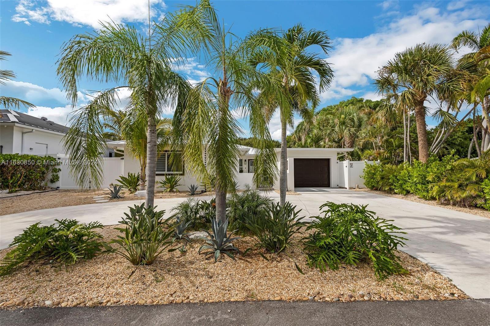 Welcome to your own slice of paradise! Presenting a mid-century modern home with a tropical oasis feel. A stunning 3 bedroom, 3 bath home with pool and spa. This hidden gem located on a barrier island nestled in the heart of Palm Beach Shores, Florida! This exquisite 3-bedroom, 3-bathroom home embodies the essence of tropical living, combining luxurious comfort with the beauty of its coastal surroundings. REMODELED in 2023 all new electric, new plumbing, new HVAC. Pool & spa installed 2023, Jandy automation. As you approach this stunning property, you'll be greeted by lush tropical landscaping that sets the scene for a serene getaway. The exterior boasts a charming blend of mid-century modern design and natural textures harmonizing with the environment.