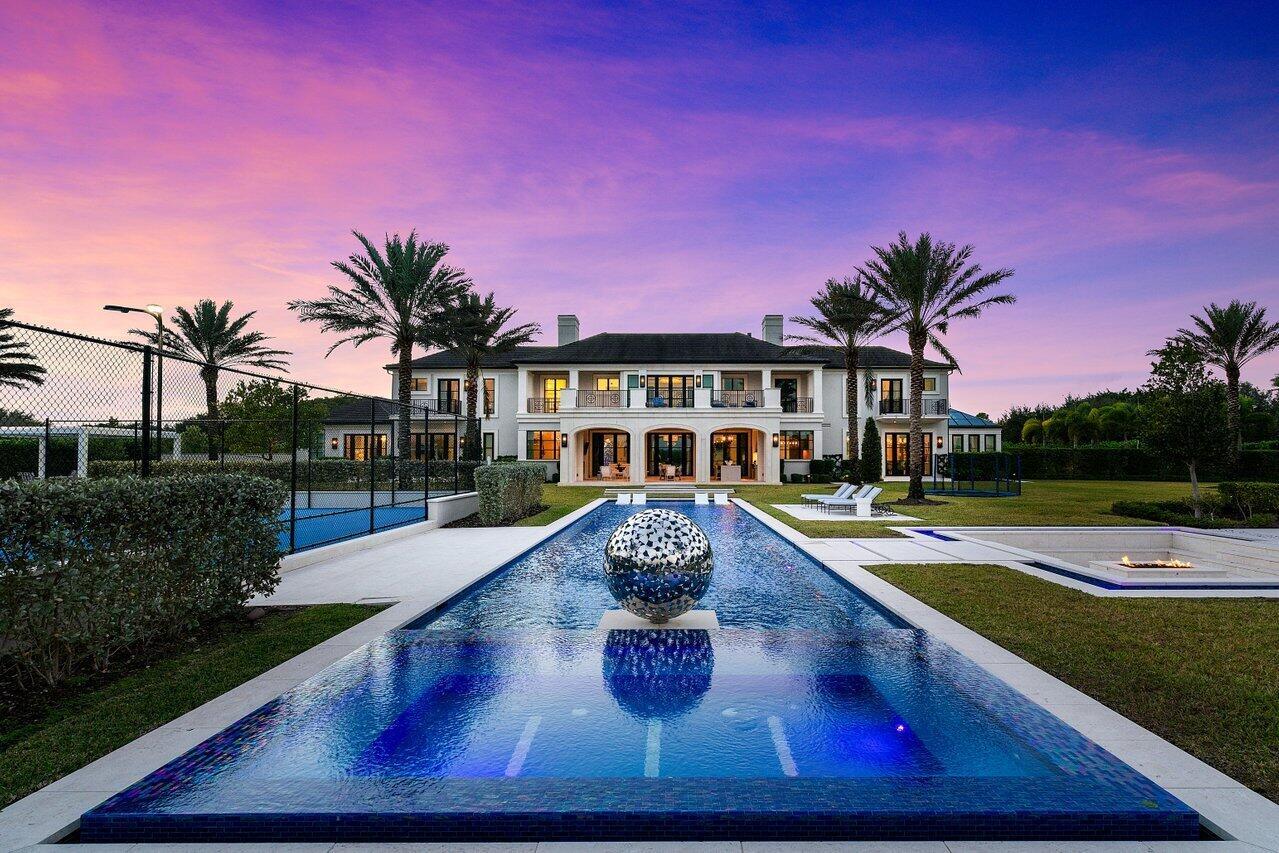 Welcome to La Maison Blanche at Stone Creek Ranch, this Exclusive Lakefront Estate epitomizes luxury, serenity & utmost privacy. Built by Ellemar/Affiniti Architects, this enclave offers an unparalleled lifestyle encompassing over 16,000 total square feet. Set on a sprawling lakefront lot, this remarkable property captivates with its breathtaking water views & idyllic surroundings. Crafted for both elegance & enjoyment, the estate boasts an east-facing pool & pavilion, a wellness retreat, multiple outdoor lounges, oversized tennis court, & a half basketball court. Every inch of the property reflects meticulous attention to detail, blending impeccable design by Marc Michaels, exceptional craftsmanship & advanced technology. This thoughtful masterpiece is the perfect home for entertaining. The Main Level, Chef's Kitchen: Fully equipped for culinary excellence. Also, a second Chefs Kitchen all High End appliances, custom Cabinetry, double oven, Fridge, Freezer, with extra sink and coffee maker, leading to a oversized formal Dining area overlooking the outside serene oasis. Elegant Entertaining Spaces: Both formal and casual areas designed to impress through the entire Estate.
Specialty Rooms on Main Level: Conservatory-style all Glass  piano room, Crestron home automation with upgraded acoustics in the home Theatre with seating for 8 to 10 people, technology room and separate Bar area. playroom with impeccable artistry. Wellness suite with Massage room, Sauna, Cold Plunge, and Separate Cabana Bath.
Spacious VIP Bedrooms: All en-suite, including a first-level VIP guest suite, with an additional VIP Suite next door with private sitting areas both facing the lake.
second-level- Incredible primary suite has private foyer, fireplace, expansive private balcony over looking the incredible Lake, separate VIP bathrooms, with dressing rooms &amp; custom closets.
 2 VIP Guest suites with private sitting areas, on either side of the Primary Suite, en-Suite walk in custom closets, and Lake Views
Craft room with custom built ins- private secondary laundry and built in steamer.
Additional Guest En-Suite with walk in custom Closets 
Outdoor Living: 76x15 heated saltwater pool with an artful sphere sculpture and Olympic with an original sculpture from artist David Harper, a sphere with beautiful color changes that light up the entire area. 20+ Person Fire Pit, tennis/basketball courts with a covered pergola. 
Advanced Technology: Crestron home automation 
Builder &amp; Design: Crafted by Ellemar and Affiniti Architects, with interior design and furnishings by Marc Michaels.
Stone Creek Ranch&#x14; Exclusive residential in Delray Beach with 37 multimillion-dollar estates. Private Security and close to exclusive Dinning and entertainment.