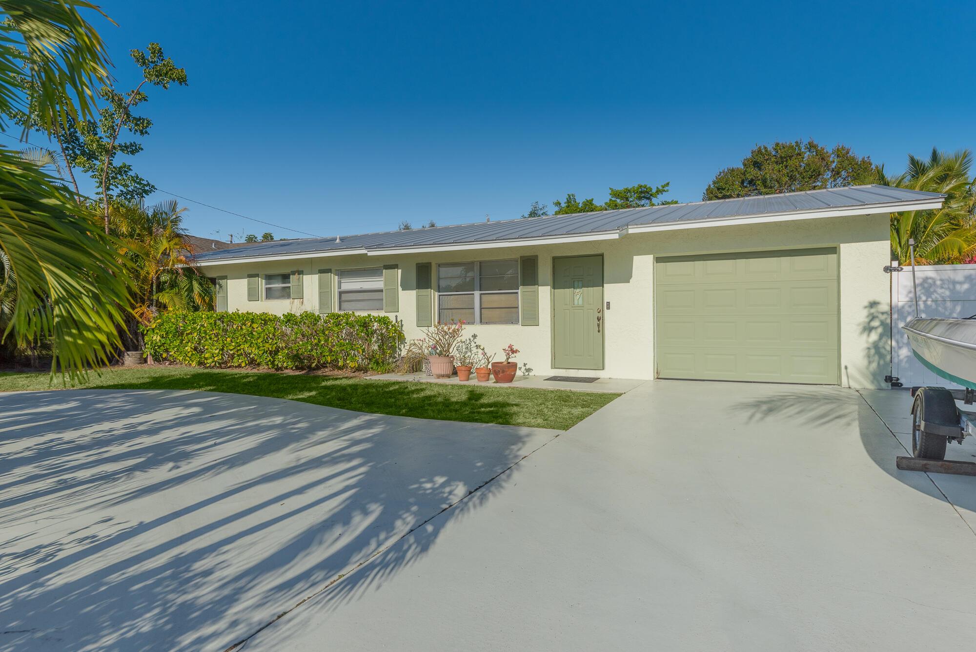 This updated 3-bedroom, 2-bath home with a 1-car garage is situated in the convenient and well-established Leilani Heights neighborhood of Jensen Beach. Just minutes from beautiful beaches, schools, and popular restaurants, the location is ideal for enjoying all the area has to offer. The home features a newer metal roof, circular driveway, vinyl flooring, crown molding, and an updated kitchen with soft-close cabinets, granite countertops, and stainless steel appliances. The spacious master suite and fully renovated bathrooms provide modern comfort, and the large backyard offers plenty of room for a pool or outdoor entertaining. A great home in a great location--don't miss this opportunity!