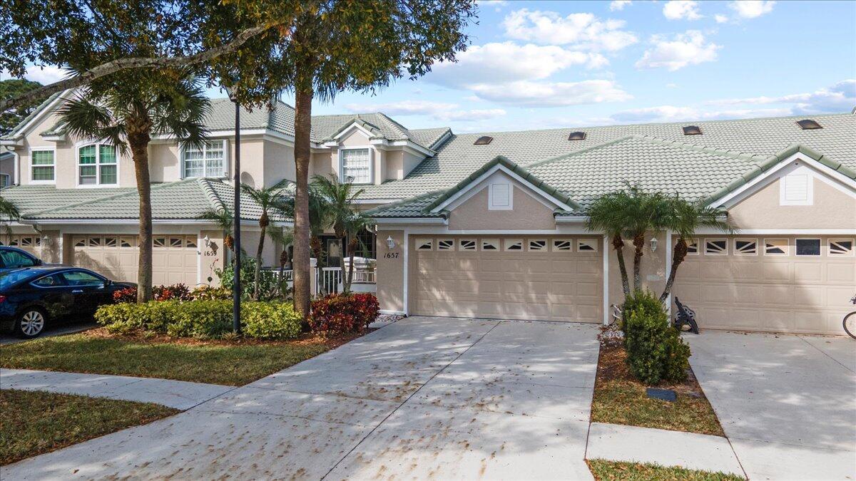 Beautiful lakefront townhome in the highly desirable Lake Charles community of St. Lucie West. This 2-bedroom, 2-bath home with a 2-car garage features stunning lake views, soaring 18' vaulted ceilings, accordion shutters, and a whole-house water filtration system. Enjoy peaceful mornings on the screened porch overlooking the serene lake. Lake Charles offers resort-style amenities, including a clubhouse, pool, hot tub, tennis, pickleball, playground, and scenic walking trails. Non-motorized boating is welcome on the community's pristine lakes. Basic cable is included, and the HOA covers exterior roof maintenance. Conveniently located near shopping, dining, and recreational activities.