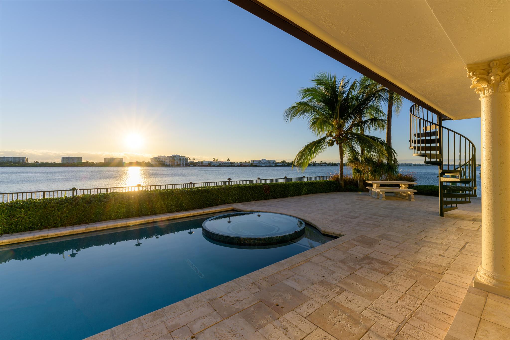 Awake to breathtaking sunrises while enjoying sun-bathed living spaces offered by this waterfront estate with coveted unobstructed East and Southeast vistas across wide water affording unparalleled security and privacy.  Merely 15 min. from downtown West Palm and Palm Beach this residence is an entertainers delight. Highlights include a two story great room, an expansive kitchen with a 17 ft quartzite stone island, dining room with southeastern water views, waterfront loggias, an outdoor kitchen overlooking the Intracoastal, and an ocean facing rooftop terrace. Remarkable views & resort-style living await from the 5 bedroom primary suite with eastern & west balconies. Affording rare provision for a combination of vessels, this boaters paradise offers an upgraded seawall and a 125' dock.