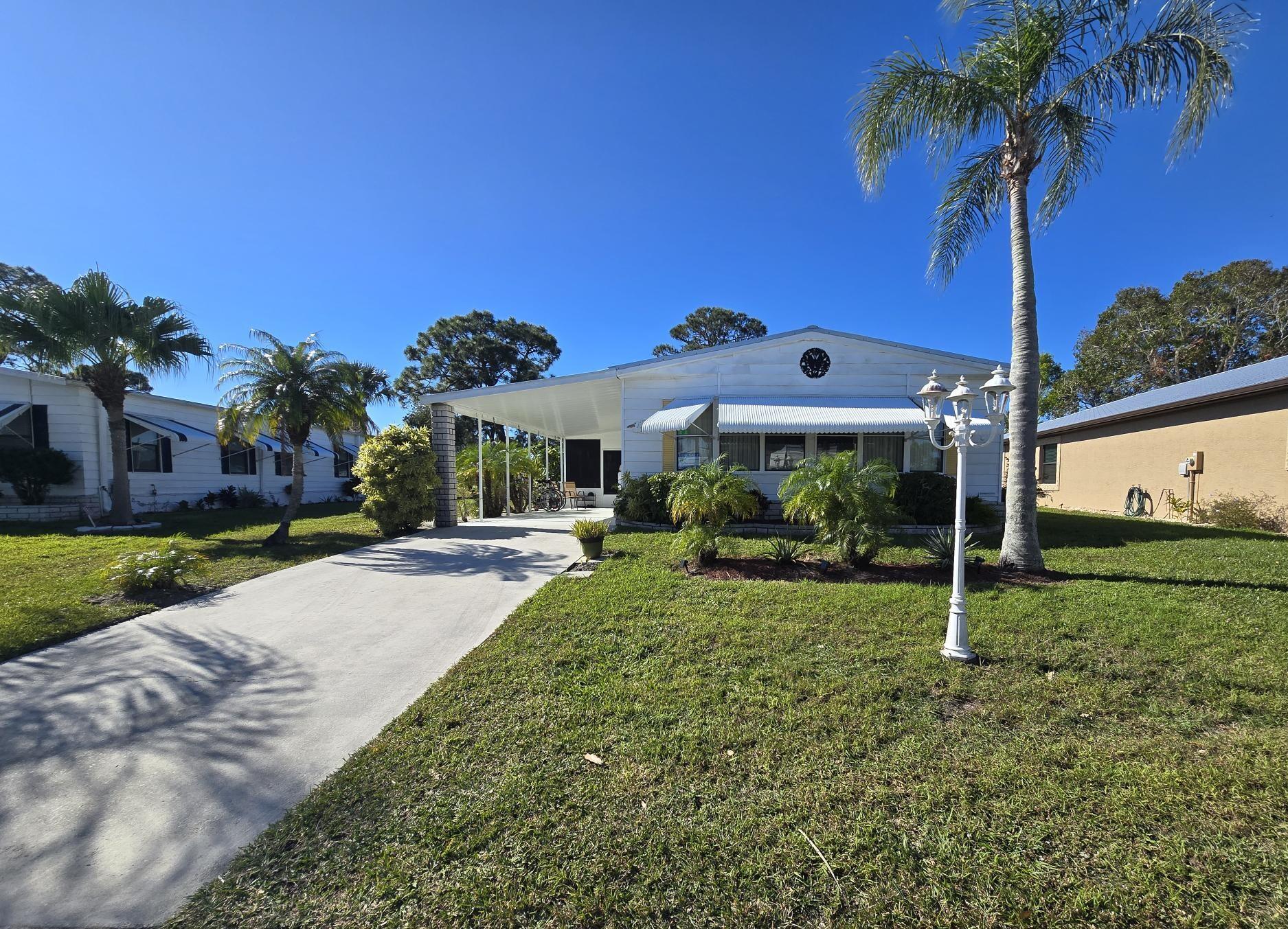 NEWLY REDUCED.. SELLERS MOTIVATED! Discover this fully furnished home on the 8th Green, offering stunning golf course views and a lifestyle of comfort and leisure. Home Features: Florida Room: Spacious enclosed Florida room with durable vinyl windows, new furniture, and breathtaking views. Roof: New metal roof installed 1 year ago with a transferrable warranty. Kitchen: Open island kitchen with breakfast bar, perfect for entertaining. Living Room: Beautifully furnished with three sleeper sofas for extended family or guests. Primary Suite: Large primary bedroom with a huge closet, ensuite featuring a sunken tub, and a separate double shower. Guest Suite: Private guest bedroom and bath. Extras: Separate TV room, covered carport with extra tie-downs, back patio overlooking the golf course.