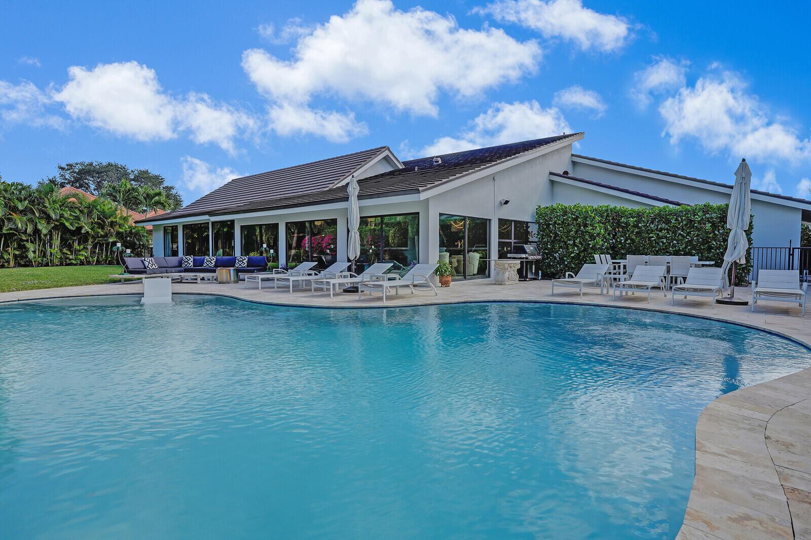A gem awaits at 4561 Oak Tree Court, a fully remodeled single-story masterpiece nestled in the prestigious Seagate Golf at the Hamlet. This 4-bedroom, 3.5 bath home with nearly 4,000sf offers a perfect blend of sophistication and serenity. providing unparalleled access to world-class amenities in an exclusive community just minutes from the vibrant heart of downtown Delray Beach. Situated on a lushly landscaped oversized lot of 0.37 acres, the property is as tranquil as it is stunning. Upon entering, you'll be greeted by elegant custom wall treatments, lighting and vaulted wood beam ceilings that create a spacious and inviting decor. The open floor plan flows effortlessly, making it ideal for relaxed entertaining and gracious indoor-outdoor living. The home boasts... porcelain wood plank flooring throughout the living areas, a remarkable chef's kitchen anchored by a massive peninsula, and floor-to-ceiling hurricane impact glass doors and windows that fill the space with natural light. Additional highlights include a new roof, two new AC units and water heater, state-of the-art kitchen appliances, solid core interior doors, hand-set porcelain tiles, wet bar and more. The outdoor living area is equally remarkable, featuring an oversized saltwater inground pool, a massive travertine deck and dining area, and plenty of green space. There is even room for a two-story guest house addition, with completed plans for a 1,900-square-foot structure included. The lush landscaping is thoughtfully designed, with a coquina stone walkway, a bougainvillea-covered entry way trellis, and a tranquil fountain enhancing the beauty and serentiy of the outdoor space. Covered parking is ample with a 930 square-foot 3 car garage plus separate golf cart entry. Seagate Country Club offers the pinnacle of South Florida living, with optional memberships that unlock access to a $12M newly renovated and meticulously maintained golf course, private beach club, water sports, pickleball and tennis courts, a state-of-the-art fitness center and spa, plus exceptional dining experiences. Experience a refined lifestyle tailored to your passions at 4561 Oak Tree Court, where every detail has been designed to elevate your living experience.