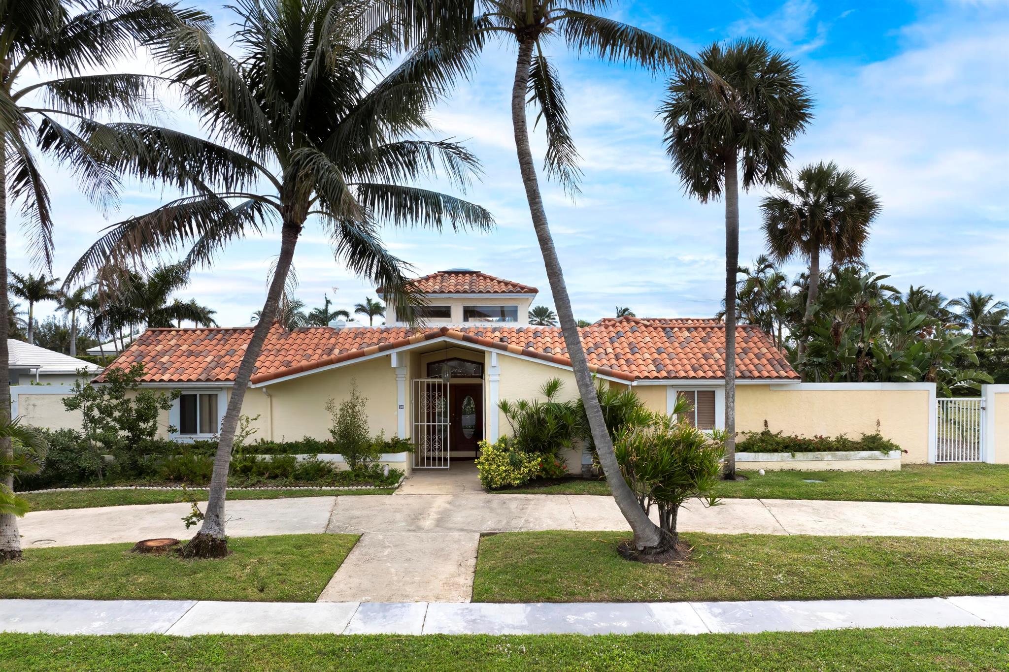 Nestled in the exclusive Point Manalapan neighborhood, this stunning Spanish-style home features five bedrooms, five bathrooms, and an elegant design centered around a serene inground pool, with most rooms opening to the pool area. The residence offers abundant natural light, privacy, and tranquility on a quiet, low-traffic street. The spacious interior exudes charm with classic Spanish architectural details, and a two-car garage adds convenience. Residents enjoy complimentary membership at the La Coquille Club at the nearby oceanfront Eau Palm Beach Resort, granting access to luxurious amenities. Located close to beaches, fine dining, and shopping, this home perfectly blends comfort, privacy, and lifestyle.