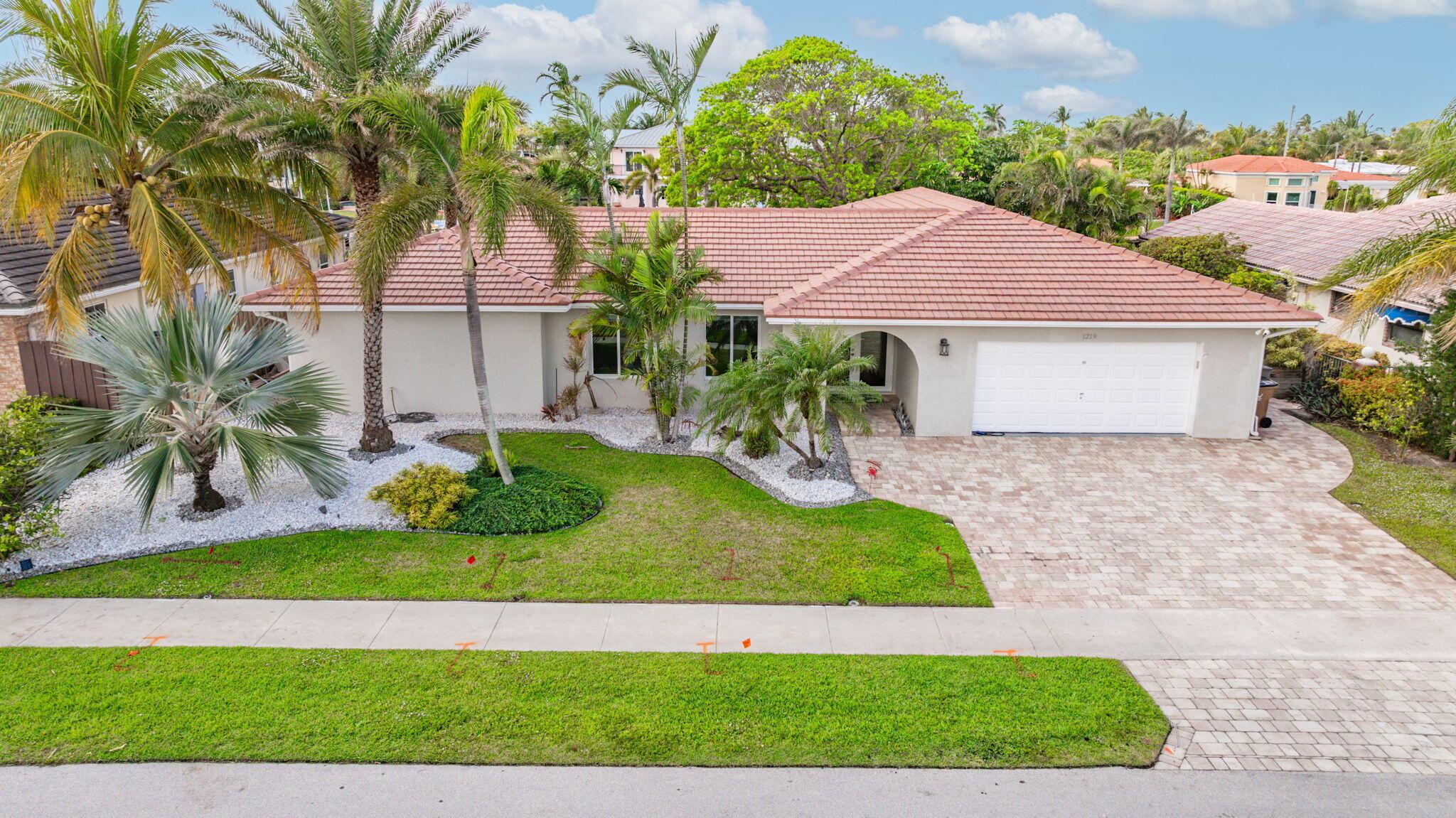 Bring your yacht and walk to the beach from this 90'  no-fixed bridge waterfront oasis! Completely renovated in 2016, this home features a spacious open floorplan with 3 large bedrooms, a bonus room perfect as an office or convertible to a 3rd bath, and sleek white porcelain tile throughout. The chef's kitchen boasts a gas stove and top-tier appliances. The property includes a private pool, cabana bath, and a beautifully designed outdoor space with expanded paver walkways, an in-ground firepit, and vibrant landscaping. Upgrades include hurricane-impact windows and doors, a 20,000-pound boat lift, a propane system for the kitchen and BBQ, and an extended driveway. A large 2-car garage with ac completes this exceptional home!