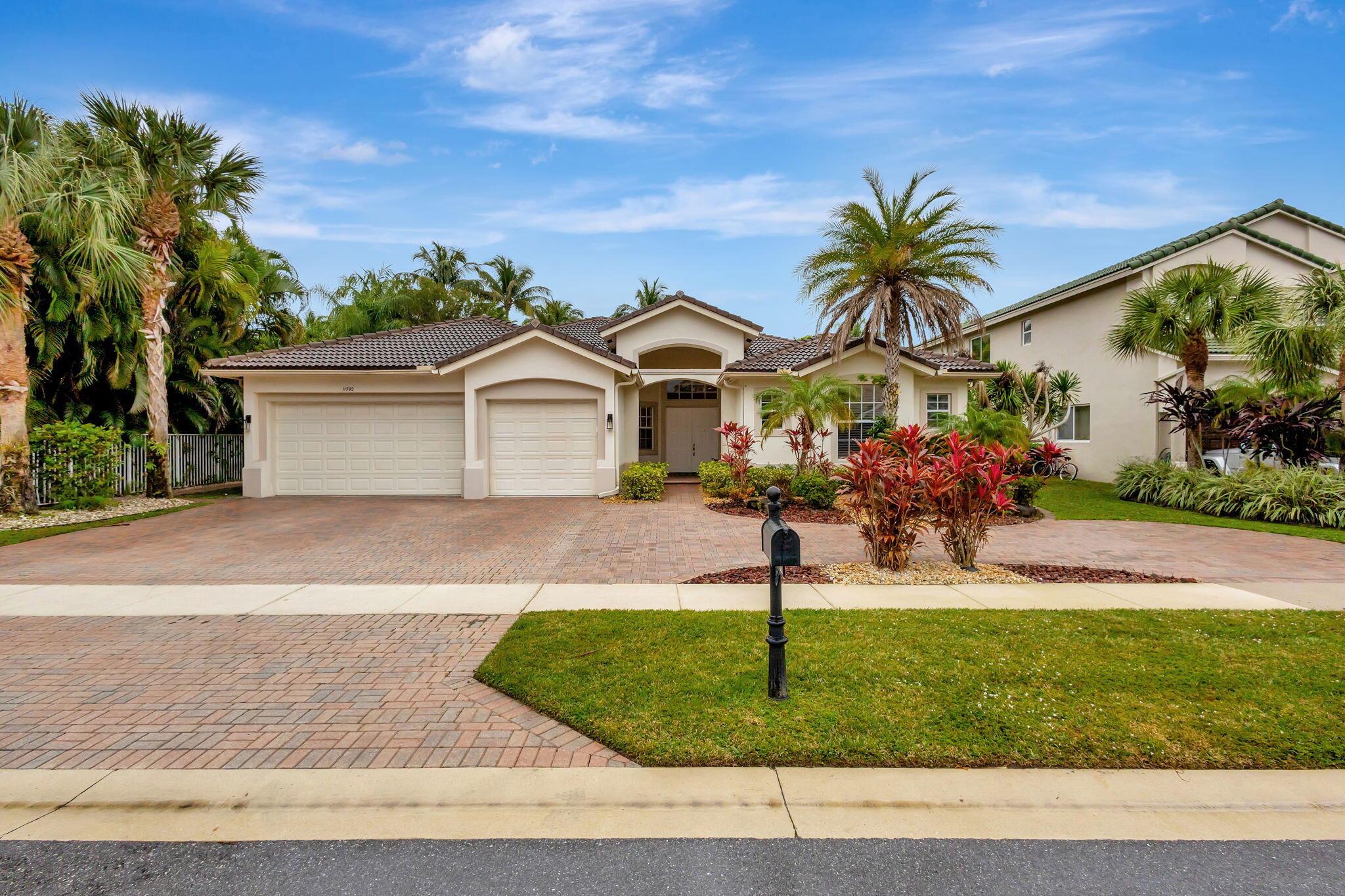Escape to paradise in this stunning one-story home nestled within a resort-style community. Enjoy breathtaking lake views from every living area, including the screened-in pool overlooking the water. This split bedroom floor plan offers privacy and comfort, featuring a spacious living area, a modern kitchen with a convenient island and vegetable sink, and tile flooring throughout for easy maintenance. The home boasts a newer roof for peace of mind and a circular driveway for added elegance. Relax and entertain in the inviting pool area, perfect for enjoying the Florida sunshine. This exquisite property offers a luxurious lifestyle with access to community amenities. Close to all horse entertainment venues, shopping, A rated schools of excellence, and everything  Wellington has to offer.