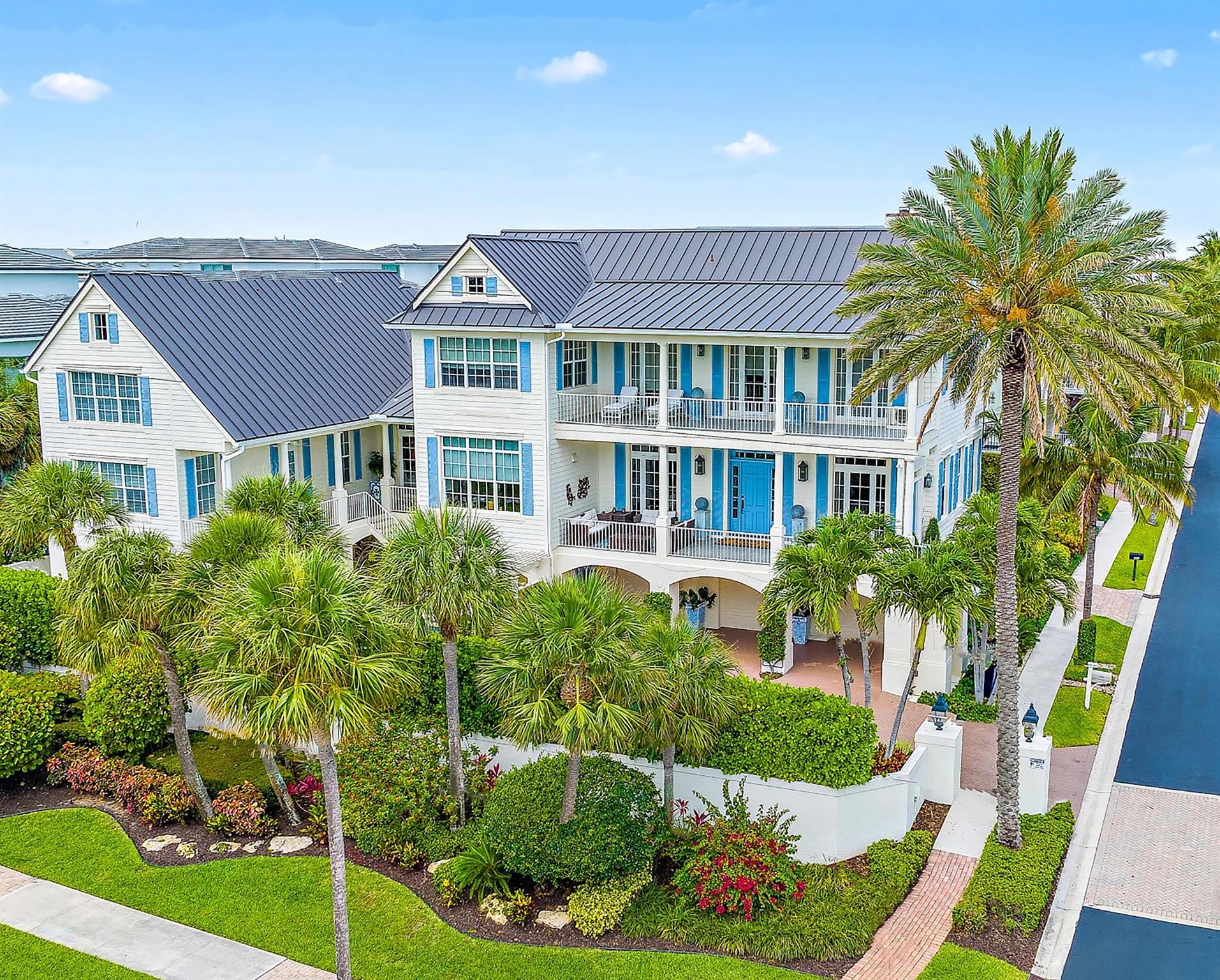 Coastal Elegance in the heart of Juno Beach.  Discover a one-of-a-kind architectural masterpiece just one block from the sparkling Atlantic Ocean. Nestled in the heart of Juno Beach, this custom-built estate overlooks picturesque Pelican Lake and Ocean Drive, offering sweeping ocean views, radiant sunrises, and the soothing embrace of gentle sea breezes.Designed to capture the essence of Key West living, this home blends timeless coastal charm with modern luxury. Step onto the expansive 11' wide porches, perfect for enjoying the tropical surroundings. Additional home features include hurricane impact windows and doors for peace of mind, a private elevator, and exquisite details such as Heart Pine Brazilian wood flooring and custom millwork throughout.The gourmet kitchen boasts-More... Viking and Sub-Zero appliances, while the stunning bar area with built-in wine storage invites effortless entertaining. Cozy up by one of the two fireplaces, or retreat to the spacious primary suite, complete with a serene sitting area and luxurious en-suite primary bath.
Outdoors, the heated saltwater pool and spa are complemented by a fully equipped outdoor kitchen and living area, perfect for enjoying the Florida lifestyle year-round. With a 3-car garage and proximity to the Juno Pier, Seminole Golf Club, and some of Palm Beach County's most pristine beaches, this home is the epitome of refined coastal living.
Experience the charm, elegance, and vibrancy of this Key West-inspired treasure in the heart of Juno Beach.