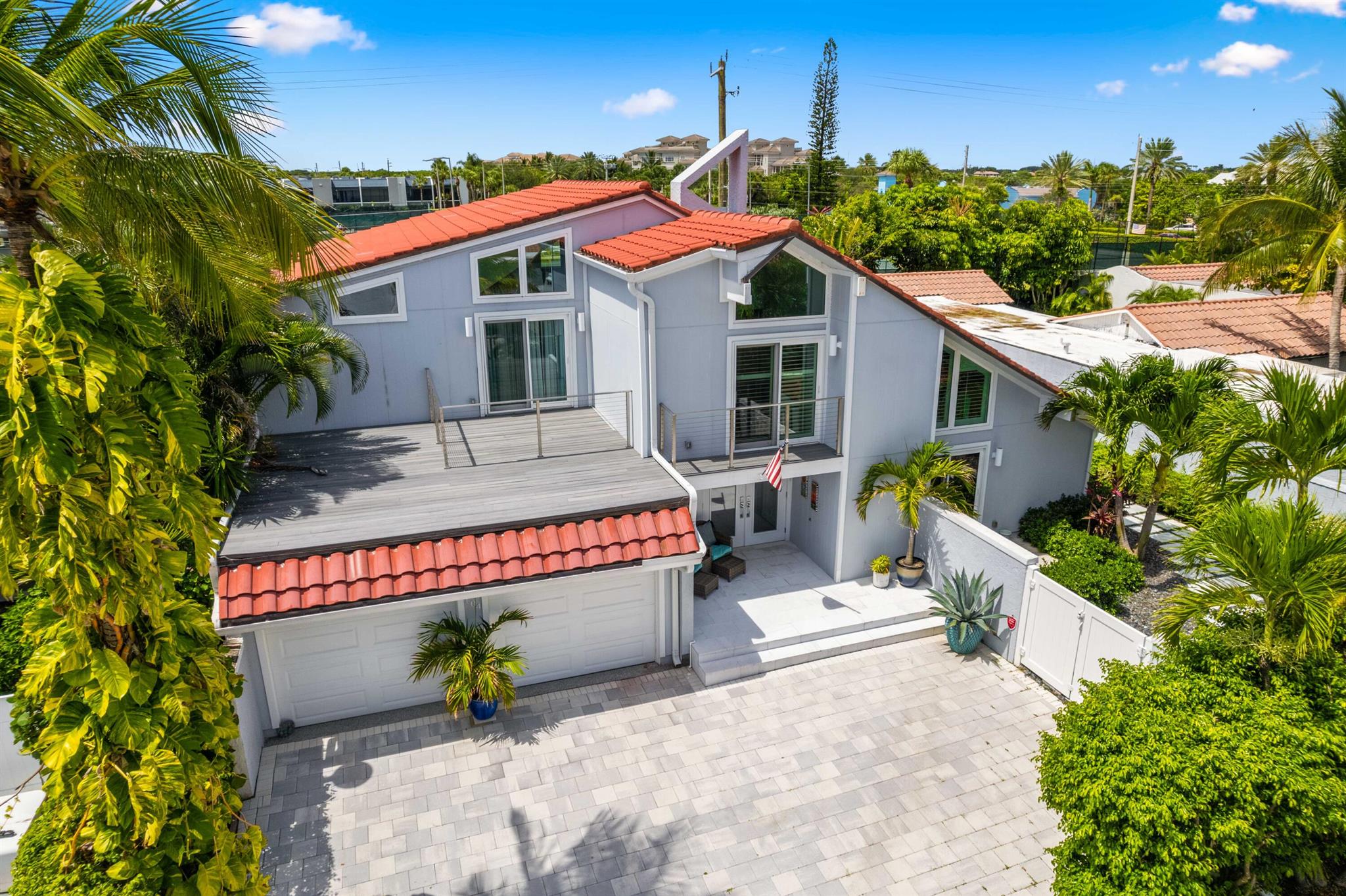 Step into an unparalleled lifestyle in Palm Beach County's prestigious oceanfront community, Ocean Walk Place. This exquisitely transformed residence, with over a million dollars in renovations, is more than a home--it's a sanctuary of refined sophistication and coastal elegance. With its coveted southeast exposure, this stunning residence showcases tranquil views of a beautifully landscaped backyard.  This home showcases an expansive open floor plan, with an abundant natural light, and refined design elements, offering 3 bedrooms, 3 baths, and 2,642 square feet of meticulously crafted living space.  Renovated in 2020 by a professional designer and premier remodeling company, this home exudes modern sophistication and functionality. The transformation includes all-new flooring, soaring