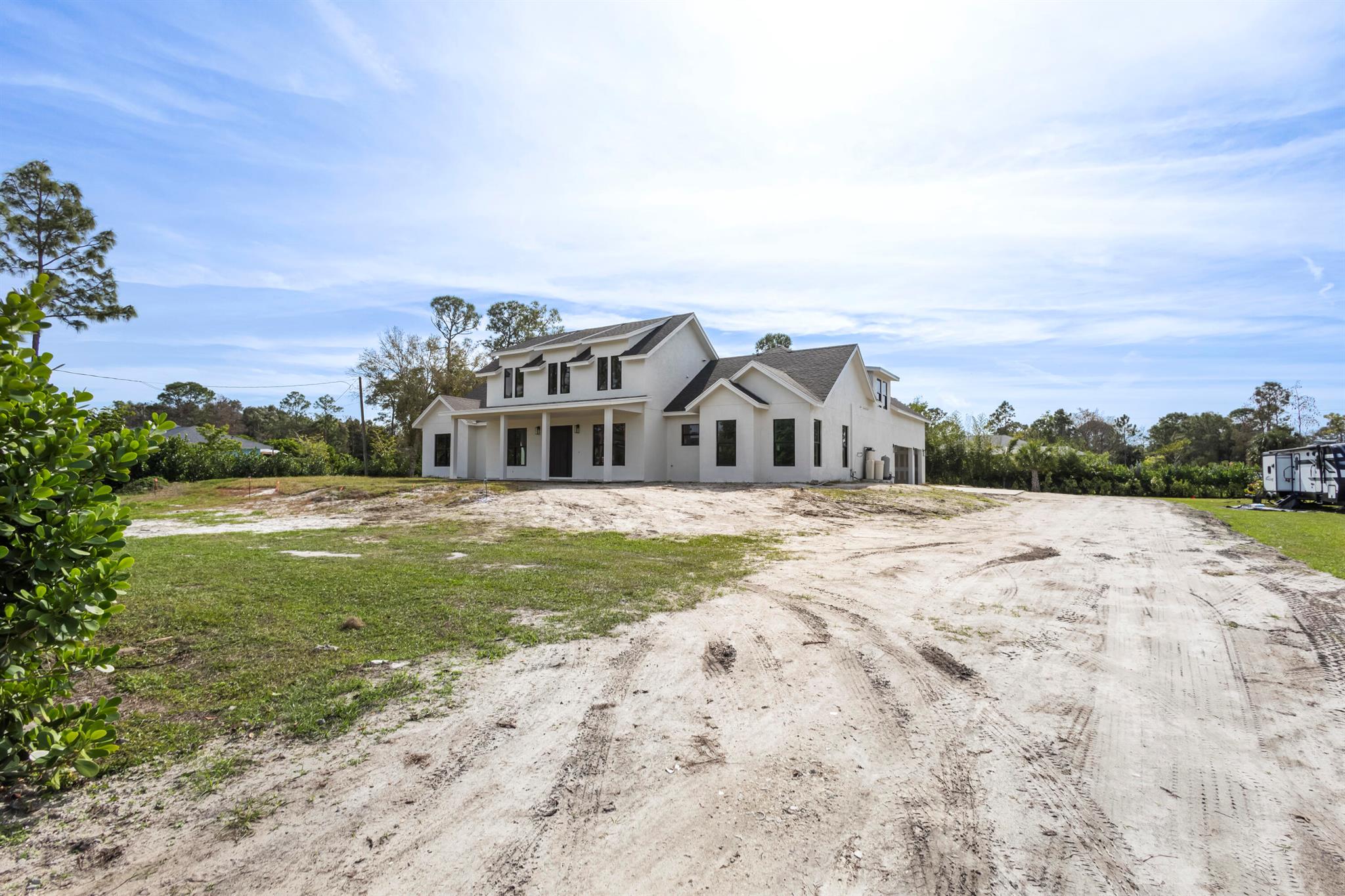 Introducing a breathtaking new construction home in Loxahatchee, FL, featuring 4 bedrooms, 3 bathrooms, and a 3-car oversized garage. This exquisite farmhouse-style residence spans 4,676 square feet and masterfully blends modern design with cutting-edge technology. The open-concept floor plan offers a seamless flow, while luxurious finishes and top-tier appliances enhance every space. Built with energy-efficient systems, this home provides an innovative living experience perfect for today's lifestyle. Set on a generous 1.14-acre lot, there's ample room to create your dream backyard oasis. Enjoy privacy and comfort, all just minutes away from the city hustle and bustle, Palm Beach beaches, Wellington, and Palm Beach International Airport.