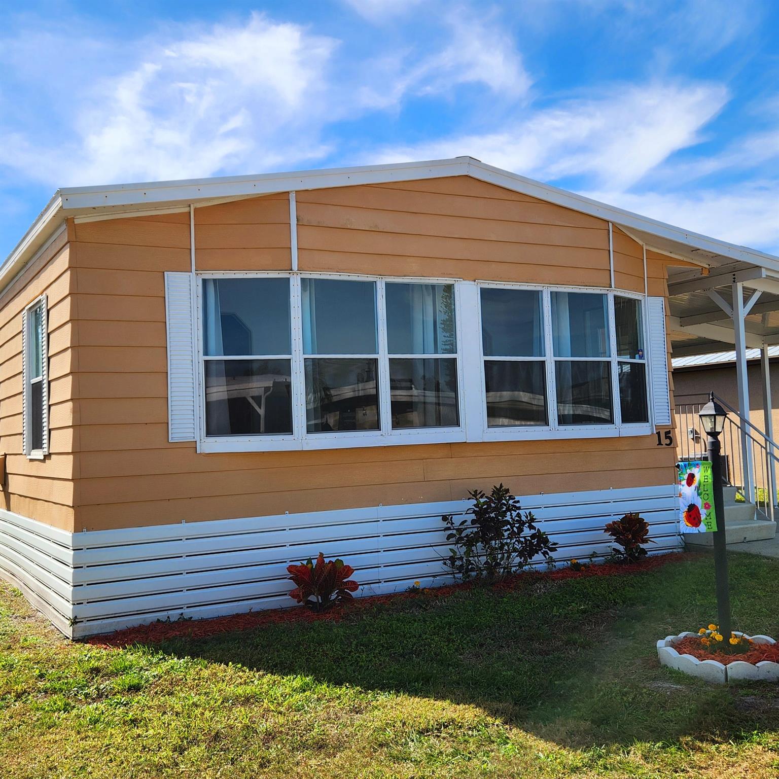 Welcome to your Florida getaway! This charming, well-maintained 2 bed, 2 bath manufactured home features a thoughtfully designed floor plan, offering both privacy & functionality, perfect for entertaining guests or enjoying your personal retreat. The kitchen has ample counter space, making meal prep & gatherings a breeze. Relax & unwind in the spacious living room, screened in or open air patio to soak up the Florida sunshine & tranquil surroundings. Water Heater 2019. You'll be pleased w/ the prime location; close to the beach, grocery stores, shopping, post office, banks, hospitals & more. Lot lease $765.82 covers Security, Cafe, Clubhouse w/activities, lawn care, trash, private golf course (free), Bingo, heated pool, pickleball,tennis, shuffleboard, bocce, gym & more!