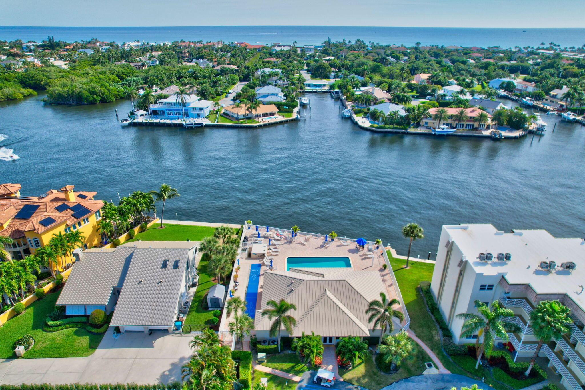 This Beautiful Move-in Ready condo has everything you need. Just bring your bathing suit. You will need it to swim in the pool located directly on the Intracoastal.  This 2 Bedroom, 2 Bath corner end unit is full of natural sunlight in every room.  Walk into your enclosed patio which stays cool on hot days. This immaculately kept home is tastefully decorated and has all you need to move right in.  Both bedrooms have a slight view of the intracoastal.  Updated bathrooms and the master has a walk-in closet.  Need more storage, there is a unit storage locker located in the Laundry Room for all your extras. AC 2023, Roof 2023, New Electric Panel in the building and units. Monthly HOA includes Water, Cable and Internet.   This Waterfront Community is close to beaches, shopping and restaurants.