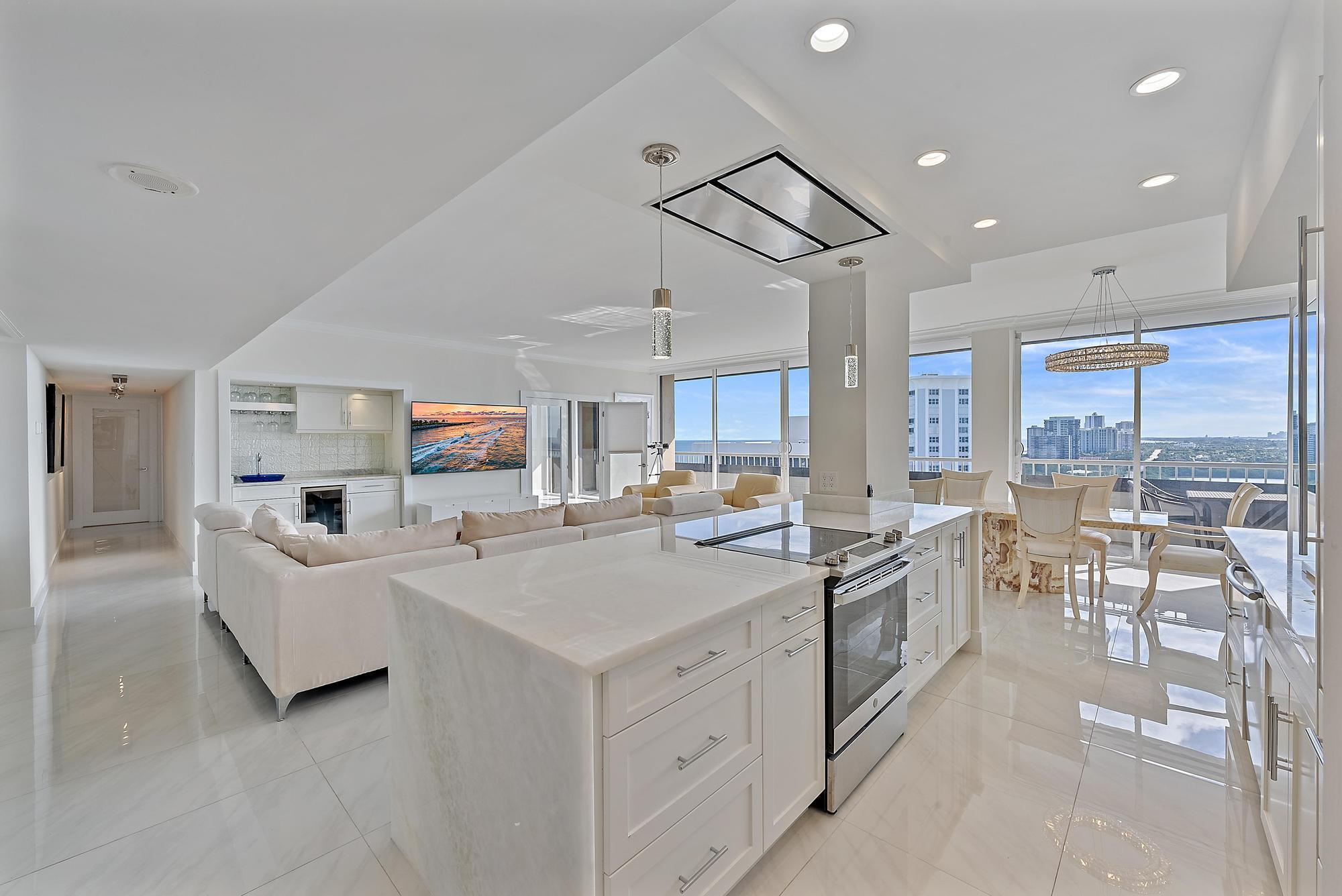 Experience coastal luxury in this exceptionally renovated Singer Island residence, with sweeping ocean and Intracoastal views that stretch to Palm Beach Island. Rare 9-foot ceilings and floor-to-ceiling windows flood the space with natural light, enhanced by desirable southern exposure. This designer-curated home showcases premium finishes throughout. The gourmet kitchen features a full walk-in pantry and high-end appliances including an externally vented range hood. Thoughtful upgrades include a spa-inspired steam shower, custom-designed closets, and a sophisticated wet bar complete with wine refrigeration. The dedicated laundry room and whole-home water filtration system add convenience to luxury. With 24/7 security and underground parking, this condo truly lives like a home in the sky!