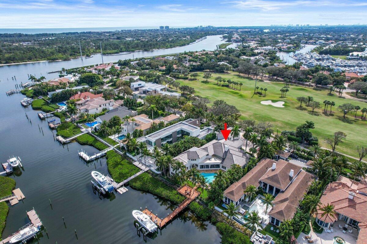 Accepting Backup Offers! Welcome to this exquisite Mediterranean waterfront estate in the prestigious Admirals Cove community. Boasting 100 feet of prime waterfrontage and a brand-new 50,000 lb-rated boat lift, this home is a boater's paradise with deep-water access. Designed for luxurious living and grand entertaining, this 6-bedroom, 8 full-bath, and 2 half-bath estate offers elegant finishes, soaring ceilings, and breathtaking water views throughout. The expansive layout is perfect for hosting, featuring two grand sitting rooms overlooking the water, a full movie theater, a stately library, and two custom-designed wet bars. The private elevator provides easy access to the movie theater and an executive office with stunning waterfront views. A sprawling screened-in sunroom creates the perfect setting for outdoor gatherings, seamlessly blending indoor and outdoor living. The home is equipped with top-tier amenities, including a 2021 roof, Flow Logic safety water shut-off system, and a home generator connected to gas lines with automatic turn-on for uninterrupted power. The resort-style pool, recently resurfaced, offers a true oasis, while the spacious 3.5-car garage provides ample parking and storage. For added versatility, a private 2-bedroom, 2-bathroom guest apartment complete with a full kitchen, living area, and separate entrance serves as the perfect in-law suite or luxury guest retreat. Situated in one of South Florida's most exclusive waterfront communities, this entertainer's dream home offers unparalleled elegance, comfort, and sophistication.