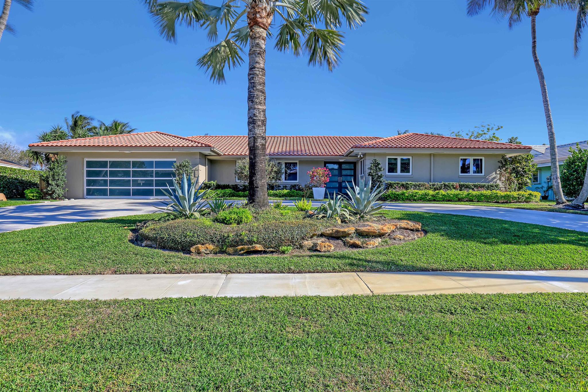 A golfers dream home...seconds from the North Palm Beach Country Club. Completely modernized to bring the ''inside out and the outside in'' for Florida living. 5 bedrooms, 3 baths, plus a private outdoor shower. Open kitchen with awesome views, all top line SUB Zero & Meile appliances with car finished walnut cabinets, a huge island and tons of storage. Architectural glass feature in Front room, custom sconces in Living room, 3 double sliders plus 2 large windows in Entertainment room overlooking large refinished pool with fantastic morning sunrises and afternoon shade.  All custom bathrooms with huge granite shower in Cabana bath and Meile washer/dryer. All windows, doors, & glass garage door Hurricane hardened. Purified H2O.