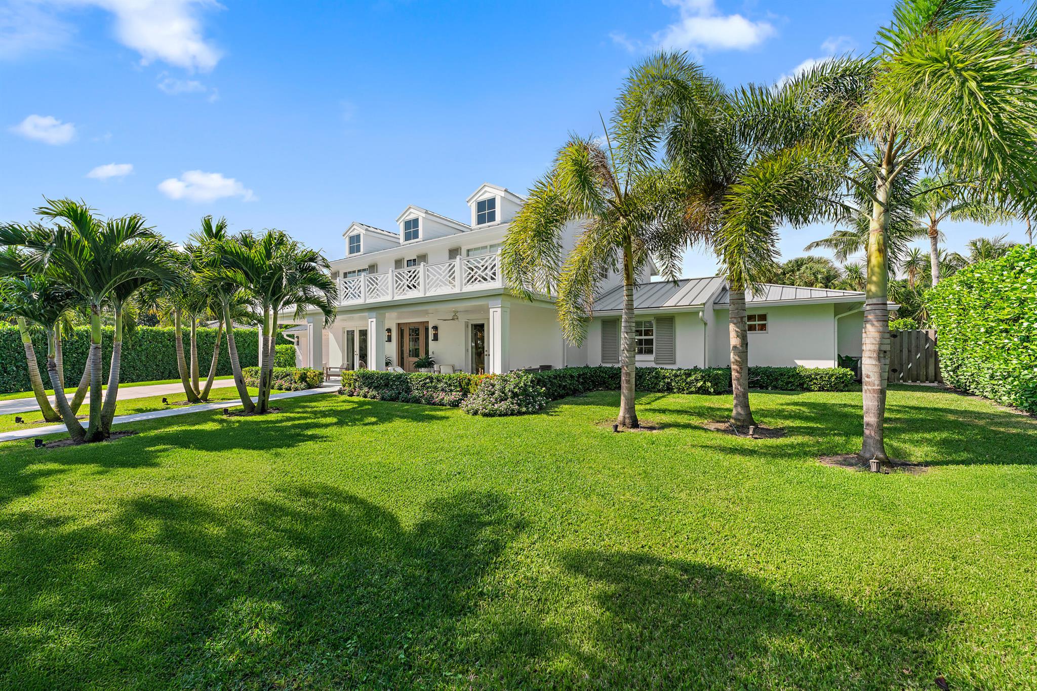 EXQUISITE Fully + Masterfully Renovated Home on 1/2 Acre in Juno Beach!  Captains Key offers a prime East of US 1 location, in a Private gated enclave of 26 custom homes.  This Impeccable residence has been thoughtfully curated to elevate the Florida lifestyle, beautifully blending indoor + outdoor living. Interior design elements fuse sophistication with comfort + highest level functionality. Every room has been hard wired for internet.  Custom wood flooring throughout.  The 2024 Chef's kitchen is spacious and features an oversized Sub Zero, quartz island, wine fridge + (natural) gas range. The spacious living area is graced by oversized picture windows + french doors leading to an extended covered lanai and HUGE backyard Oasis. A wide hallway leads to the ultra private Primary bedroom suite with two Very Large closets and a stunning modern bath. The upper level  features a second family room area, great for gatherings or quiet enjoyment.  There are 3 spacious guest bedrooms, impeccably designed + maintained.  Everything in this home is NEW + offers professional design precision. From the enchanting landscaping that welcomes you to the thoughtfully designed interiors, this home is truly a delight on every level.  Outdoor areas are Exceptional - from the chic front porch to the expansive back yard + custom lap pool (2024 equipment).  A wraparound covered lanai with summer kitchen completes a perfect space for entertaining.  Enjoy one of the most coveted locations in all of the Northern Palm Beaches... Captains Key is just minutes from Juno's gorgeous Ocean beaches, fine shopping + dining as well as educational and cultural venues.   20 minutes to Palm Beach International airport and the Island of Palm Beach.   A beautiful life awaits you in this magnificent home + property!