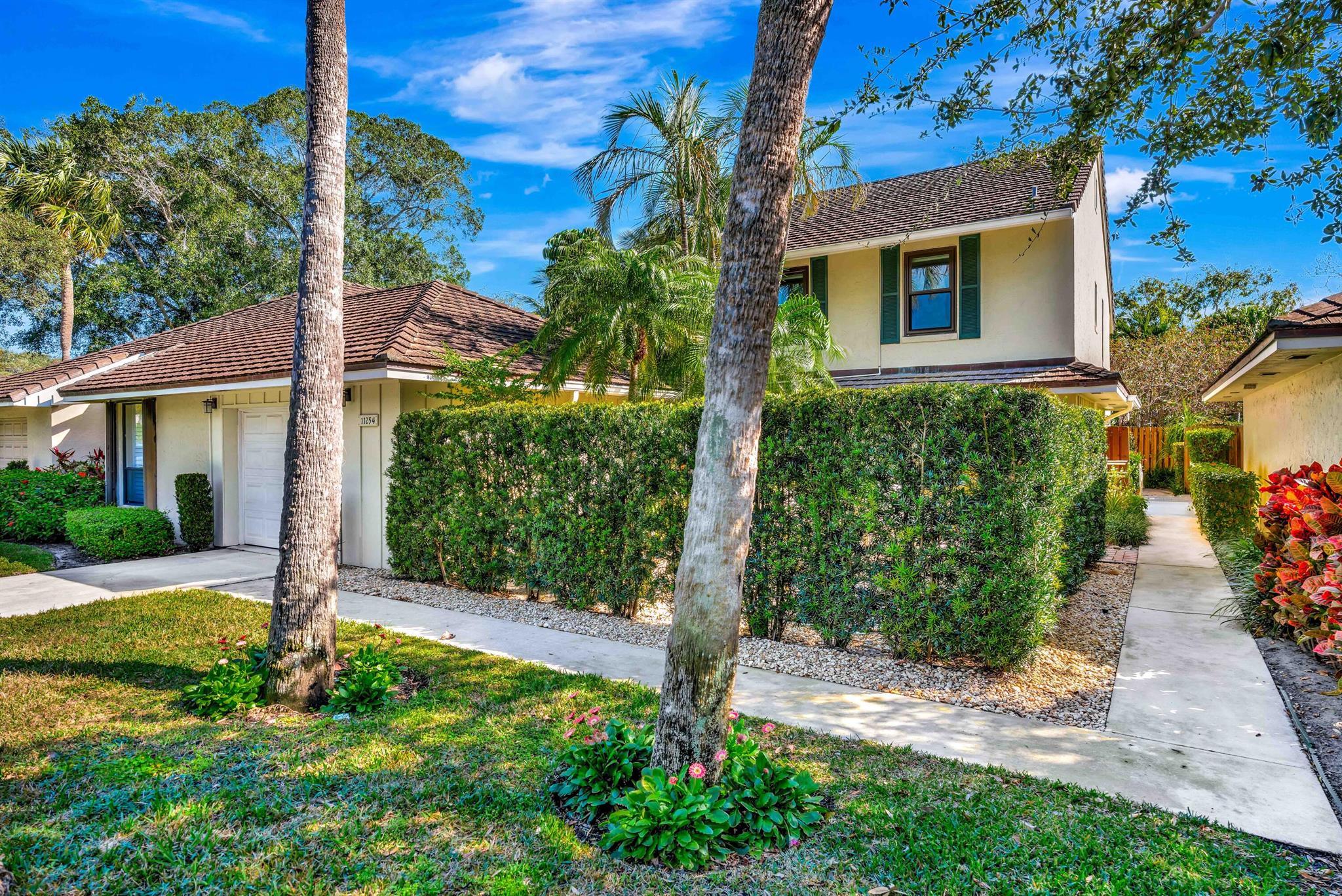 Welcome to the gated enclave of charming Twelve Oaks! This lovely 2 story townhome with a vaulted ceiling offers 2257sf of living space with 3 bedrooms, 2.5 baths, a cozy loft, an office/ FL room and a one car garage. The primary suite is conveniently located on the first floor and includes a beautifully updated primary bath featuring a curbless shower and dual vanities. Additional upgrades over the years include impact glass windows, an impact garage door, updates to the kitchen and guest bath, flooring, & new A/C (2024 & 2025). With 2 private patios, there is plenty of outdoor space to enjoy the LF sunshine! HOA fee includes: cable, internet, exterior maintenance (including the roof), exterior painting (every 7 yrs), lawn maintenance landscaping and security. Other amenities in this pet-friendly neighborhood: swimming pools, tennis and pickleball courts, and onsite management. Twelve Oaks is a marina community and, as available, offers boat slips for lease or purchase with no fixed bridges to the Palm Beach inlet. In the heart of North Palm Beach, this home is conveniently located with only minutes ot the beaches, shopping, fine dining, golf courses and the airport.