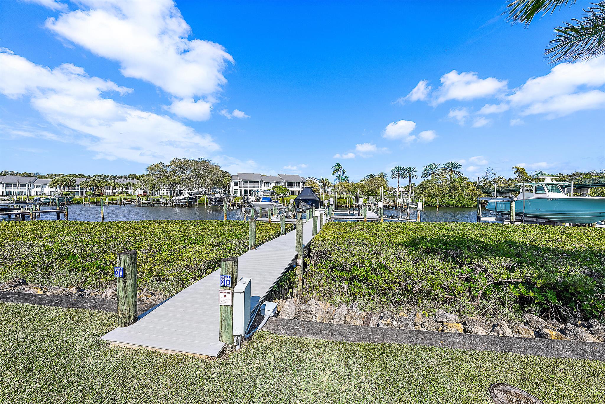 Experience the epitome of waterfront luxury in this first-floor Harbor Home on Captains Way, nestled in the prestigious Admirals Cove community. This exceptional residence offers the convenience of single-level living and a private dock for your boat, all within one of Jupiter's most exclusive enclaves.For the active enthusiast, Admirals Cove boasts 45 holes of golf, tennis and pickleball facilities, and a deep-water marina with easy access to the Intracoastal Waterway and Atlantic Ocean. After a day of adventure, unwind with fine dining at the clubhouse, where gourmet cuisine and impeccable service create the perfect social setting.Beyond your doorstep, Admirals Cove offers an unparalleled lifestyle with world-class amenities designed for ultimate relaxation and recreation. Indulge in a day of pampering at Bluewater Wellness, where the state-of-the-art spa features hydrotherapy pools, a salt suite, a steam room, and sauna all dedicated to enhancing your well-being. The full-service salon ensures you always look and feel your best, while the fitness center offers expert training, group exercise classes, and even physical therapy services to keep you in top form.

This Harbor Home is not just a residence it's a gateway to an extraordinary lifestyle. Whether you're setting sail from your own dock or indulging in the luxurious amenities of Admirals Cove, every moment here is designed for enjoyment.

Don't miss this rare opportunity to own a piece of paradise in one of South Florida's most sought-after communities.