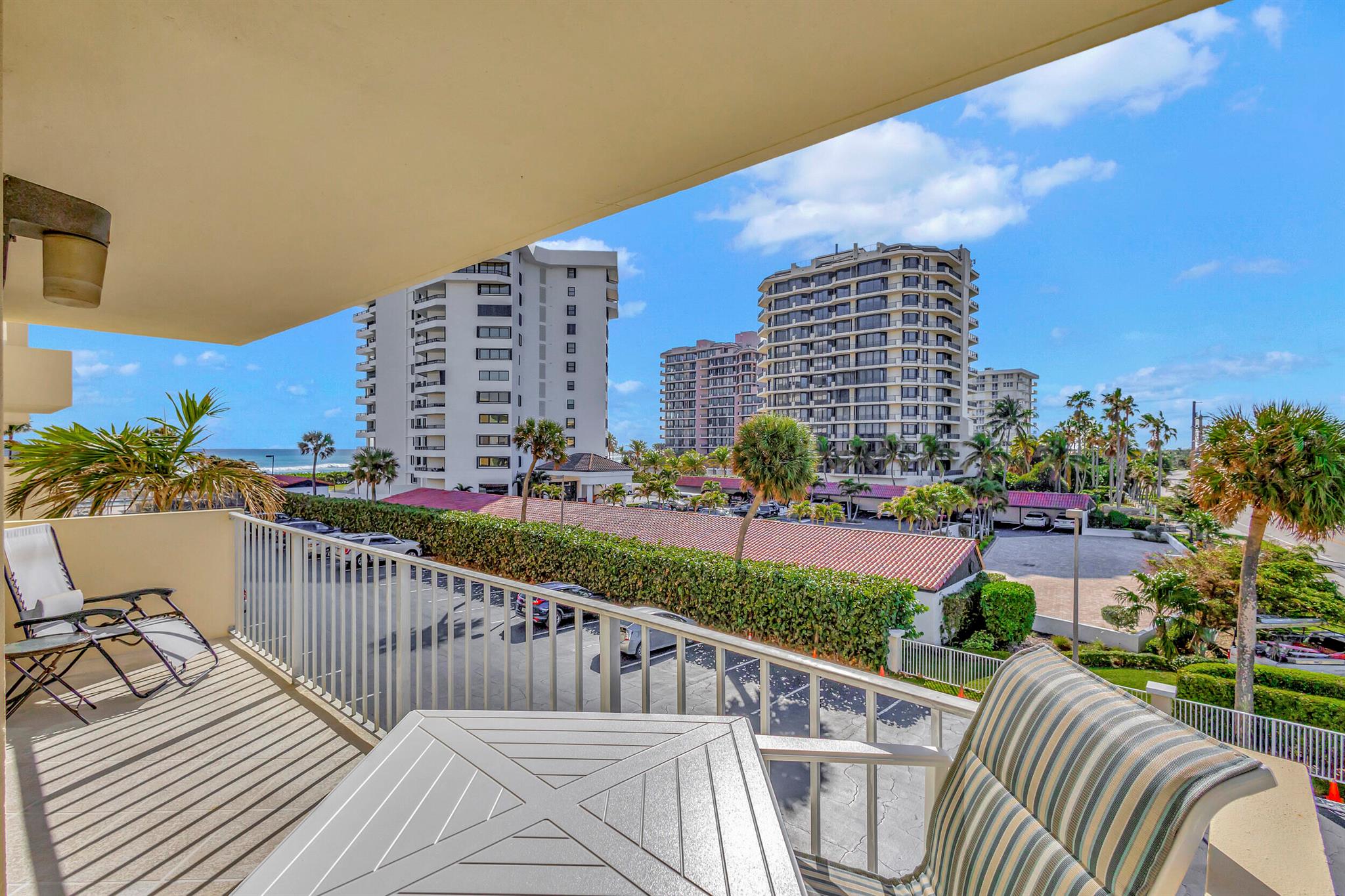 This updated 2 bedroom, 2 bathroom corner unit is the perfect spot to enjoy views of the Atlantic Ocean. This condo features a renovated kitchen and bathrooms, offering a modern and fresh feel, while crown molding throughout adds a touch of elegance. With a spacious layout and stylish finishes, it's the perfect place to enjoy comfortable living. Impact windows and sliders let in plenty of natural light throughout this condo. In the family room, roll-down shades offer convenience and privacy, while the bedrooms feature classic plantation shutters. The wraparound balcony is the perfect spot to relax and take in the beautiful surroundings. Located in a well-maintained building, this is a perfect opportunity to own your slice of paradise with low maintenance costs!