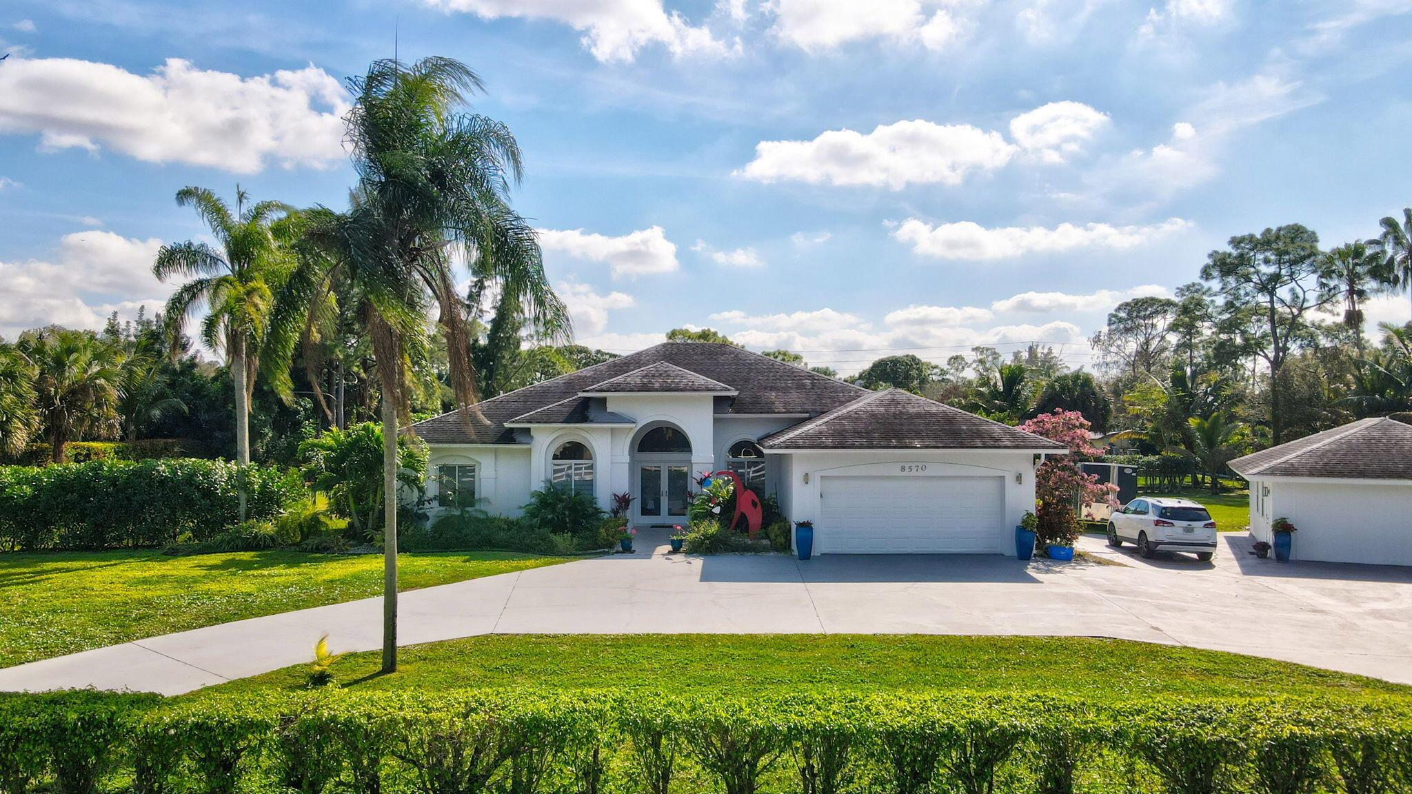 Stunning Modern Estate in Palm Beach Ranchettes - No HOA, Horses Allowed!Welcome to this beautifully renovated  property in the highly sought-after Palm Beach Ranchettes community! Situated on a 1-acre lot, this modern oasis offers a spacious 2,718 sq. ft. main house with 4 bedrooms, 2.5 bathrooms, and a 2-car garage, along with a 660 sq. ft. detached 2-bedroom, 2-bathroom mother-in-law suite--perfect for guests, extended family, or rental income.Every detail of this home has been thoughtfully upgraded, featuring large-format porcelain tile flooring throughout, elegant natural quartzite and marble countertops, and an open, contemporary design. The oversized circular driveway provides ample parking, while the screened-in patio seamlessly extends the indoor living space with matching porcelain flooring.

Enjoy the freedom of no HOA restrictions&#x14;bring your horses, RVs, or even build a stable! This prime location offers top-rated schools, easy access to shopping, dining, and the Turnpike, all while maintaining a peaceful, private atmosphere.

A rare opportunity to own a move-in-ready luxury estate with endless possibilities&#x14;schedule your showing today!