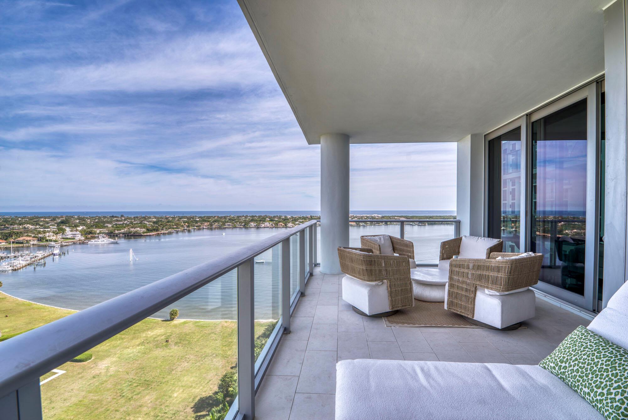 Welcome to Nirvana! The premier condo community in North Palm Beach with sophistication, elegance and ocean views as far as the eye can see. This bright expansive towering 18th floor condo with floor-to-ceiling windows is the coveted #01 line, with unobstructed views east over Lake Worth Lagoon, Lost Tree community to the ocean, and north to Jupiter. Custom wall textures, treatments, design, and lighting set this condo apart from the rest of the building. This unit had all the developer upgrades when built. Luxe quartz countertops with waterfall edges, a huge island with seating, and open floor plan allows for views of the ocean from every main living area. The primary bed and bath are significantly sized with a huge his/hers walk-in closet to boot.