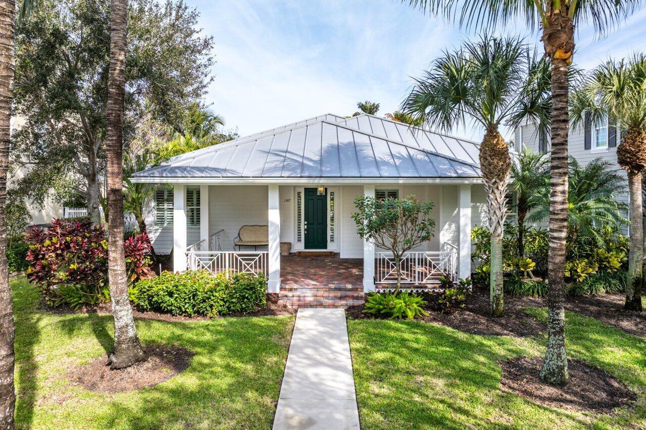 Stunning Key West Style Home welcomes you with an expansive front porch & lush Tropical Landscape.  Featuring gorgeous hardwood floors & plantation shutters, the open flowing floorplan offers an elegant foyer, formal living room (or optional 3rd bedroom/study), gourmet island kitchen and spacious great room defined by custom accents and design features. The tastefully appointed Master Suite includes a large walk-in closet plus a beautiful Master Bath inclusive of an oversized shower, soaking tub, double sinks & vanity. The pleasing guest suite features an adjacent bath with a shower/tub combo. The Exquisite Outside Entertainment area features a large covered & screened patio overlooking an open freeform, heated, salt chlorination pool creates a private tropical oasis! The best of Abacoa!!