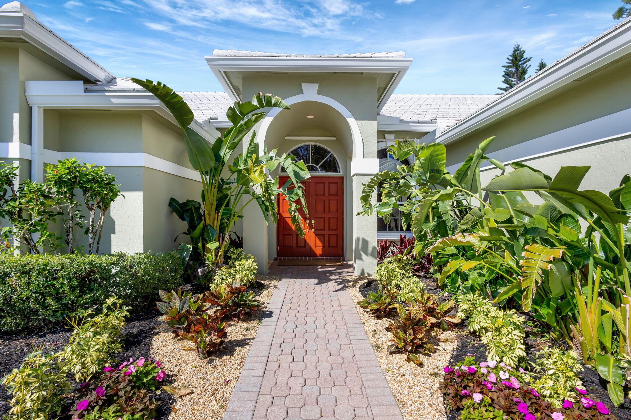 This beautiful, upgraded house has 4 bedrooms, 3 baths & 3 car garage. It is located in North Passage a manned gated community located in Tequesta & has a private lushly landscaped oversized .43-acre corner lot. Owned by the original owner this home has many upgrades to mention such as wood flooring, updated bathrooms, new roof, water heater, a/c & ducts, & also has accordion hurricane shutters. The neighborhood has great amenities for new Buyers to enjoy such as a community pool, tennis, pickleball, fitness, playground, library, clubhouse & more. For better bedroom privacy this home has a 3-way split plan layout. The Master suite is well appointed with two good-sized walk-in closets w/built in dressers, the bathroom has dual vanities & separate shower & tub, also a compartmented toilet. The kitchen is open concept to the family room and nook area features include wood cabinets, marble counter tops. stainless steel appliances, pantry and has a snack bar. The main areas of the home have 11 ft volume ceilings, the bedrooms laundry room and garage have 9 ft ceilings. The family room has custom built in shelves and bookcases. The sprinkling system is on a well. The patio's, front entry, walkway and driveway have decorative pavers. The 3rd bath is a cabana bath for backyard convenience. This home is a must see don't miss out on this beautiful home so come view it today.