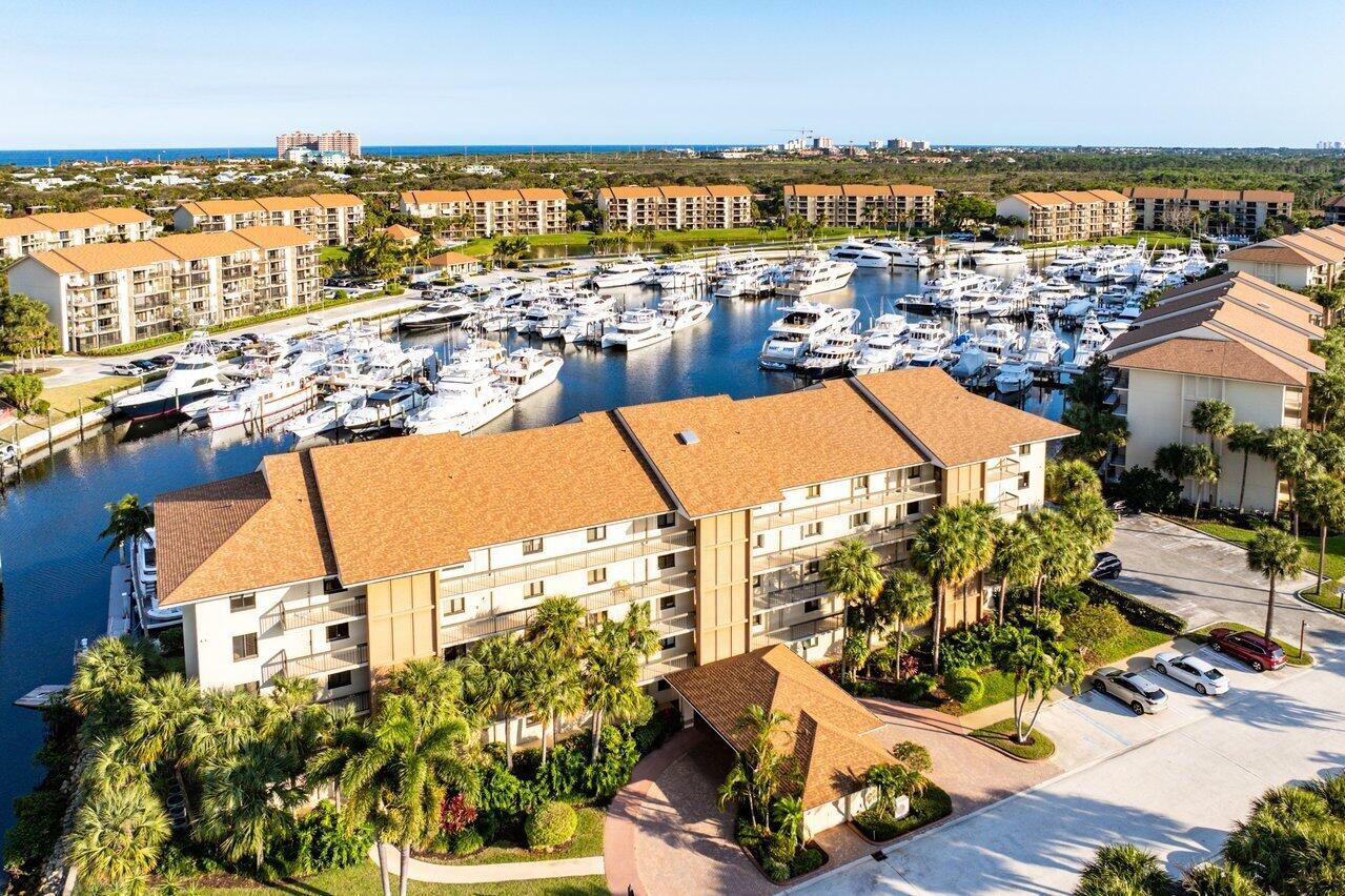 Experience waterfront living at its finest in this beautifully appointed condo overlooking The Bluffs Marina, just minutes from Jupiter's stunning beaches. This immaculate unit boasts a coastal feel and has been lightly lived in as a seasonal retreat. A/C and water heater were replaced in 2017. It also features complete accordion shutters, recently replaced sliding glass doors for added peace of mind, solid wood doors, plantation shutters. Furniture is negotiable, excluding the nautical buffet chest. Enjoy breathtaking marina views and the ultimate Jupiter lifestyle. Marina at the Bluffs is conveniently located on the Intracoastal Waterway, 0.8 miles from the aqua blue Atlantic Ocean, and a short distance to a supermarket, pharmacy, restaurants, and more. Don't miss this rare opportunity!