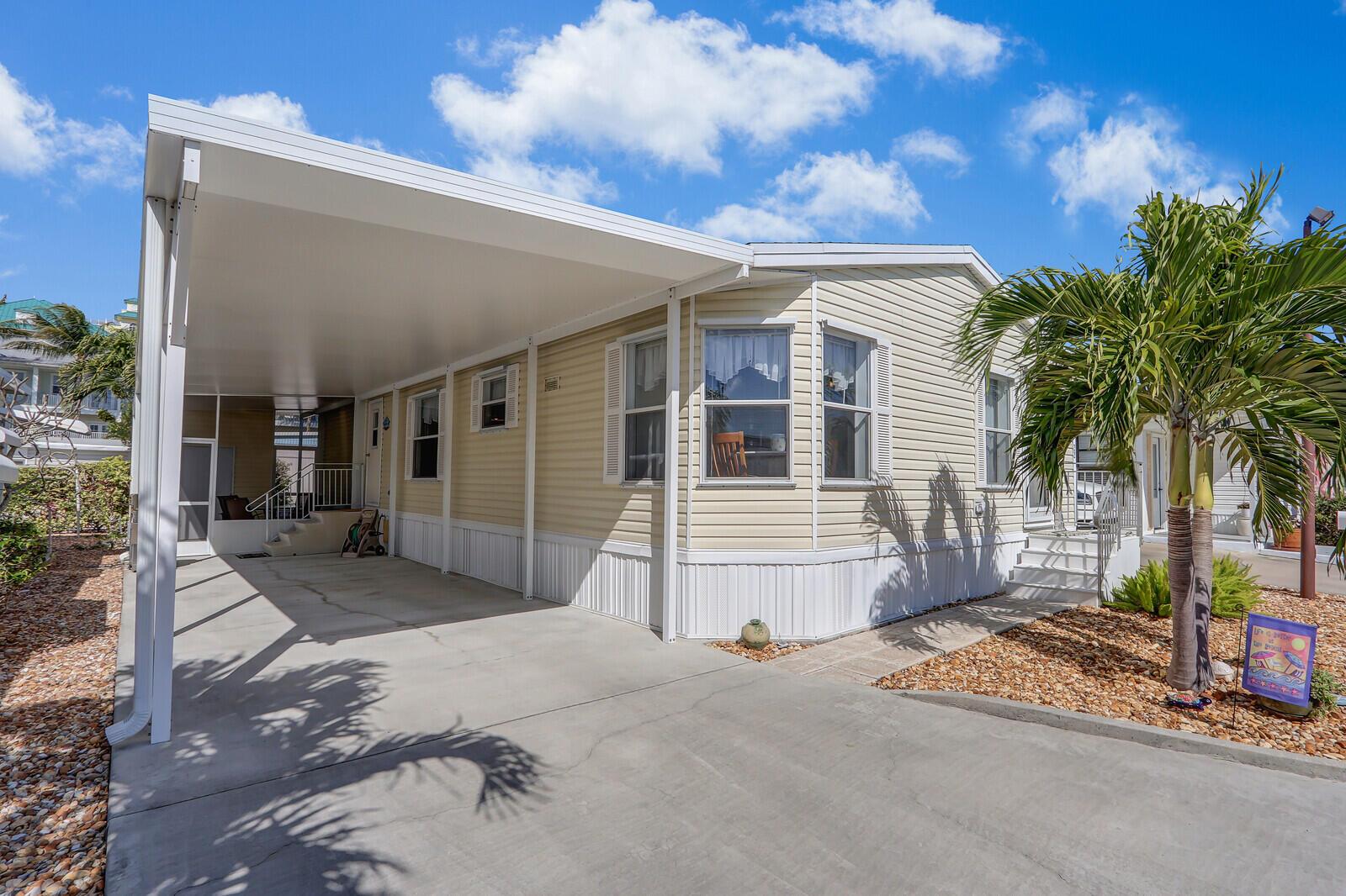 This location is hard to beat!  Steps from the beach, this is a rare find in Juno Beach! You own the land with this 2- bedroom/2 bath double wide manufactured home. $60k+ in upgrades & meticulously maintained. Enjoy a peaceful setting and quiet neighborhood just steps from the beautiful beaches of Juno and Jupiter.  Close to restaurants, supermarkets and retail shops.  Newer roof w/transferable warranty plus custom storm shutters every opening. The newer master bath is huge, and the home includes a lot of extra storage, plus a workshop and covered outdoor screen room. Extra-large carport can accommodate two cars.  Low condo fees include lawn maintenance, water and sewer. This hidden gem will not last long!