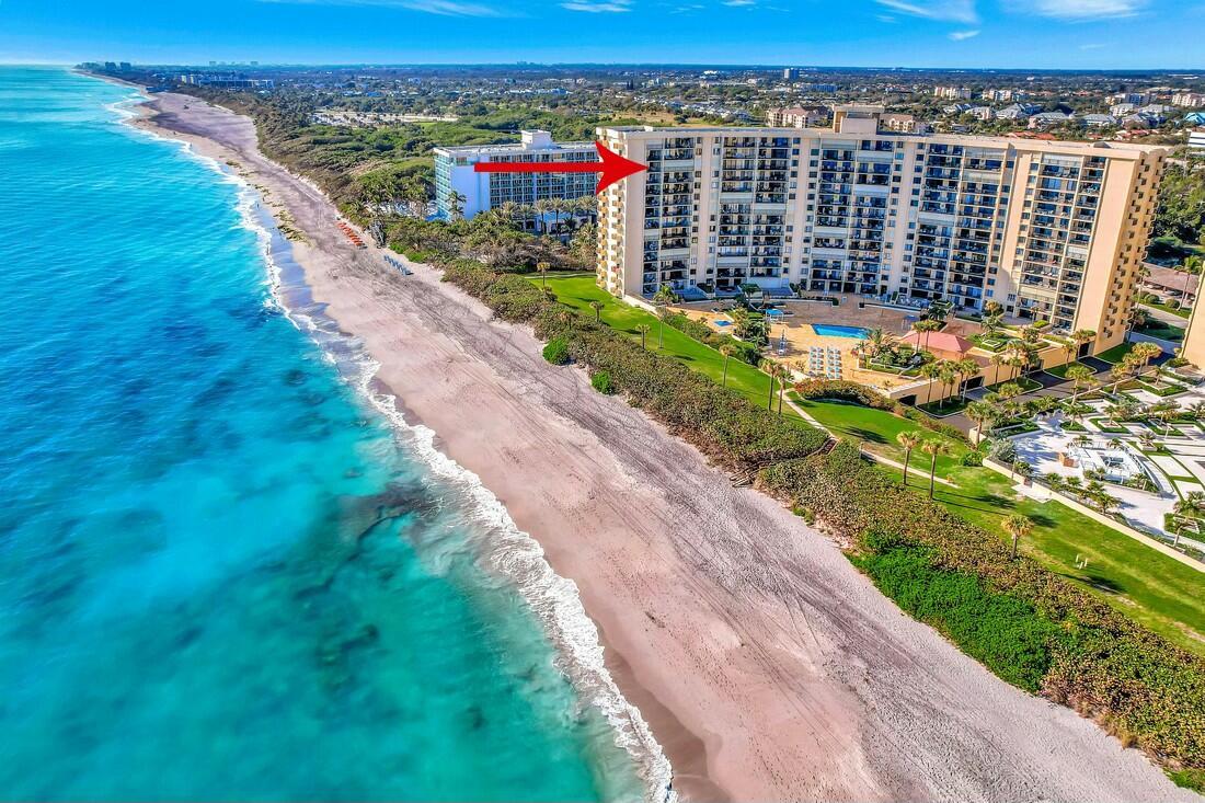 This is a must-see oceanfront corner unit located directly on the beach in Ocean Trail! This beautifully updated 2-bedroom, 2-bath condo offers 1,270 sq. ft. of move-in-ready living space--freshly painted and fully turn-key. Enjoy three private balconies with sweeping, unobstructed views of the Atlantic Ocean, Jupiter Inlet, and Juno Beach Pier--ideal for soaking up the sea breeze and breathtaking sunrises.This exceptional end unit includes access to resort-style amenities, such as two heated pools, tennis courts, a spa, sauna, fitness center, community room, and exclusive direct access to a private beach.