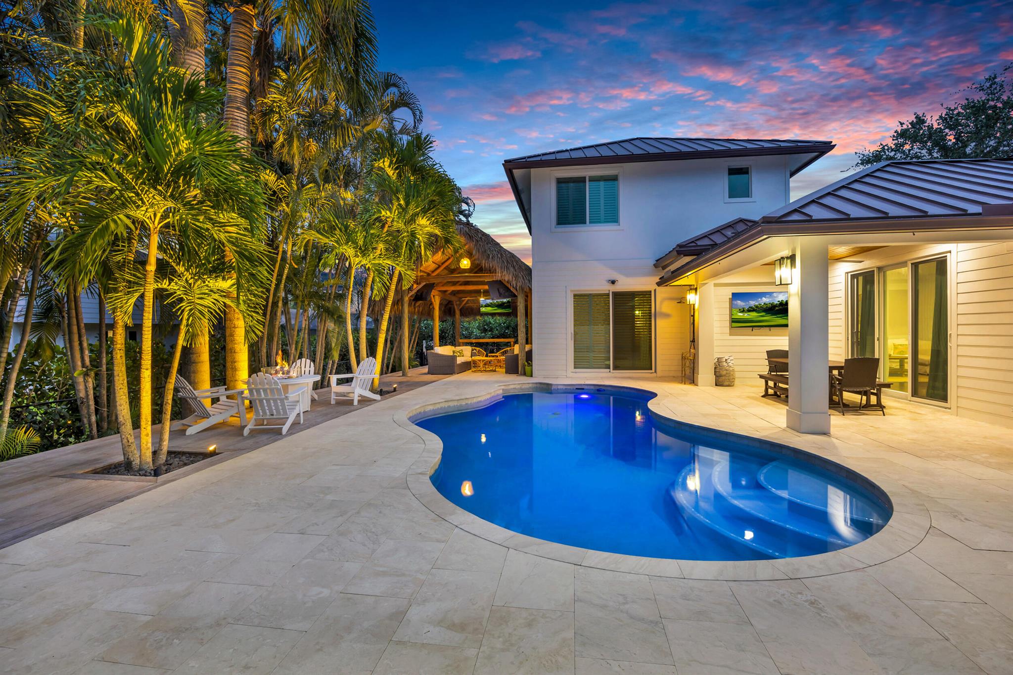 Six bedrooms including two primary suites and four full bathrooms at this renovated inside and out, 3,490 sqft home in Tequesta! This fully CBS built home was remodeled to entertain! Open living area with kitchen and bar seating, gas range. Sliding doors open to a beautifully refinished patio, and pool. Outdoor tiki hut and turf. Metal roof 2022. Impact windows and doors. Five bedrooms are downstairs including a master suite and three full brand new baths. The additional primary bedroom and bath are on the second floor with a large walk-in closet. Two new ACs, two water heaters (one propane tankless). New pool pump. New refrigerator and dishwasher. Oversized laundry room with built-ins. Located one street away from desirable Tequesta Country Club. Martin County low taxes