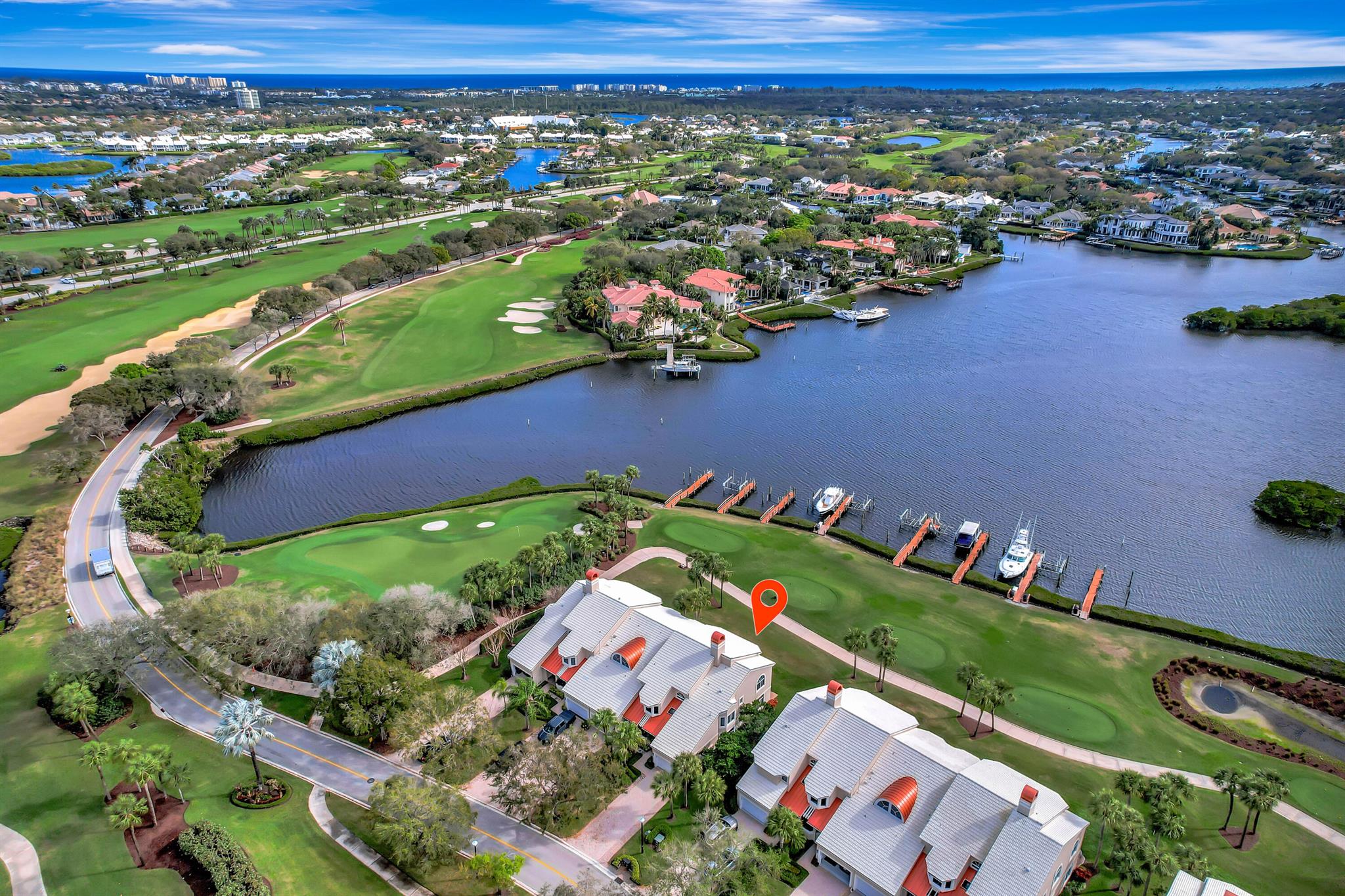 Experience luxury coastal living with unparalleled wide water and golf views! This beautifully updated first-floor Harbor Home offers two bedrooms plus a versatile den that can serve as a third bedroom. The sleek, modern white kitchen features a stylish tile backsplash, Miele and SubZero appliances, and two renovated baths. Designed for comfort and style, the home boasts impact windows and doors, along with elegant travertine and wood flooring. Boating enthusiasts will appreciate the Aztec dock with a lift, accommodating a 34' boat and providing direct ocean access with no fixed bridges. Enjoy the ease of condo living and make the most of the world-class amenities at Admirals Cove.