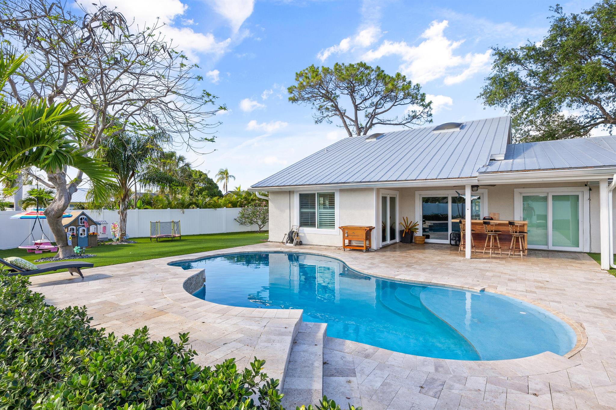 With an unparalleled location on a quiet cul-de-sac, this beautifully updated 3 bedroom pool-home is styled with elegance and ambiance. The home offers an abundance of character with volume ceilings, a formal dining room, plantation shutters and an expansive loft. Accessed via a spiral staircase, the finished loft can serve as an office, play-room or a potential 4th bedroom. The residence affords the owner an extensive list of recent upgrades. These include the comfort and security of impact windows & sliders, a new AC, a modern eat-in kitchen with quartz counters, custom cabinetry and stainless steel appliances, charming baths, an exquisite salt-water pool, pool deck and patio, an expansive synthetic turf rear yard, fencing and gutters. When it's time to relax or entertain guests, step outside and enjoy the residence's sublime private backyard oasis. With no home to the rear, this location is one of a kind. The Village of Tequesta is currently constructing a "passive" non-recreational park on this vacant parcel to the rear of 15 Hemlock. The park is to be called Remembrance Park and will feature native trees and shrubs, a butterfly garden and walking paths. See the attached rendering in Photos.

Located in desirable Tequesta Pines, the home's location is more than perfect. Whether your interests lie in fishing, boating or just enjoying the beach, the blue waters and beaches of the Atlantic, the Loxahatchee River, and the Intra-Coastal Waterway are minutes away. The Tequesta area is also home to numerous world class golf courses, fine dining, and entertainment. 15 Hemlock Lane is not just your next home, it's your future lifestyle.