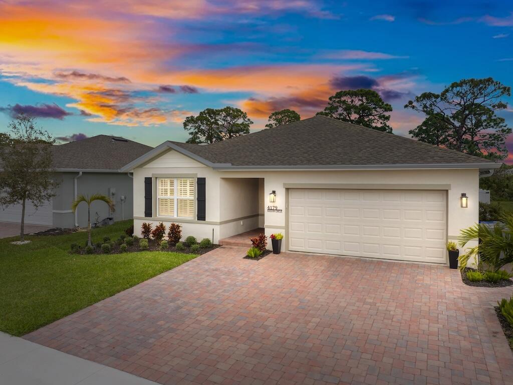 The property at 4179 Keeson Circle, Vero Beach, FL 32967, is a beautifully designed single-family home built in 2022. It features 3 bedrooms, 2 bathrooms, and 1,533 square feet of living space. The open-concept layout includes granite countertops, stylish cabinetry, and tile flooring in the kitchen and dining areas. Ceiling fans are installed in all rooms for added comfort.This home offers an extended 6-foot driveway for additional parking convenience, a fully fenced-in backyard for privacy, and a cozy outdoor fireplace with paver flooring--perfect for entertaining or relaxing.Community amenities include a pool, clubhouse, and gym