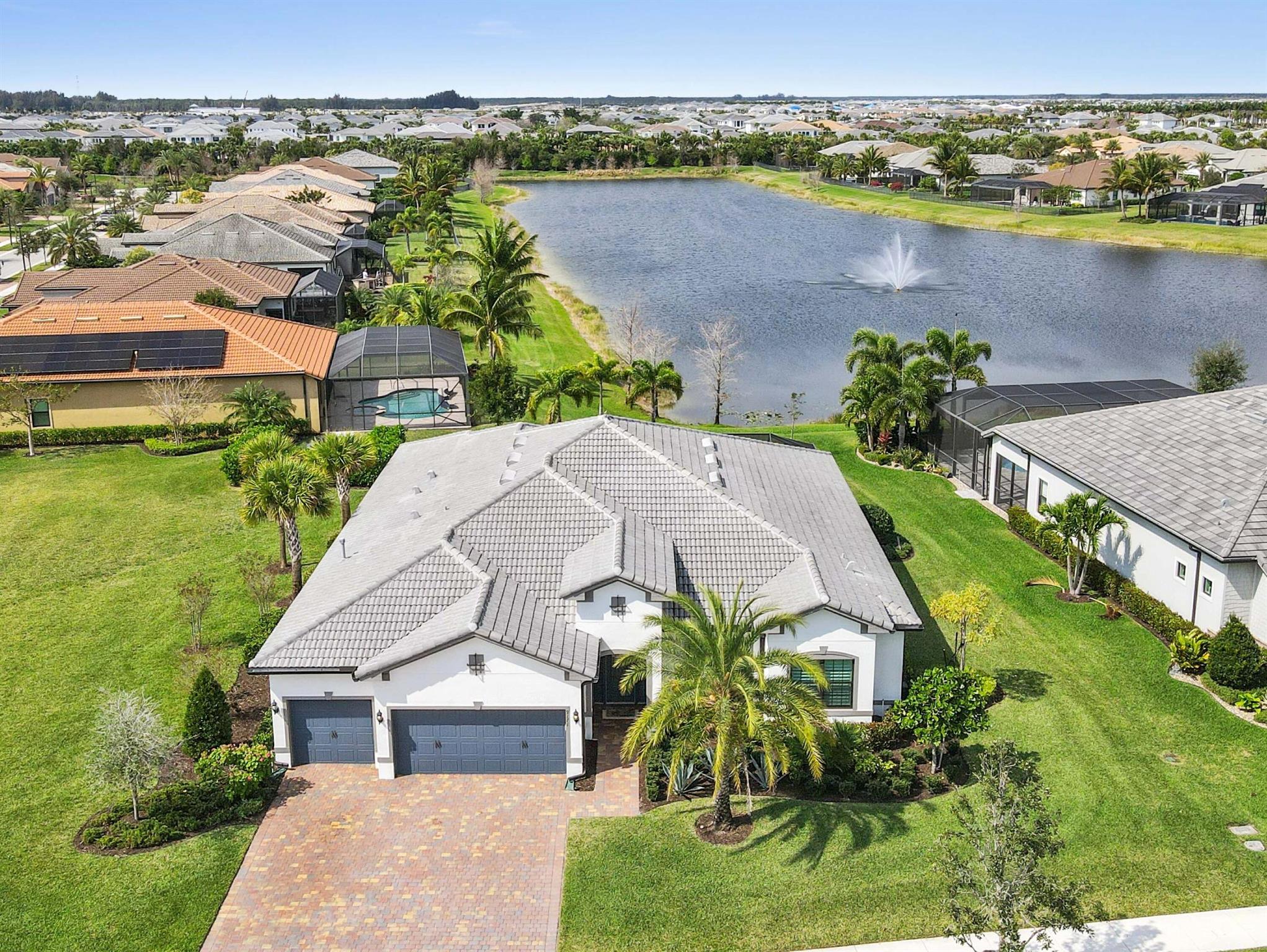 Experience unparalleled elegance in this stunning 2021-built waterfront home, perfectly situated on an oversized lot in the prestigious Ancient Tree community. This 4-bedroom, 3-bathroom residence, complete with a dedicated office, is true luxury Florida living. Designed for both grand entertaining and everyday comfort, the open-concept layout showcases a chef's kitchen featuring top-of-the-line stainless steel appliances, a gas range, custom island, upgraded cabinetry, and a stylish wine bar. The great room is adorned with a coffered ceiling, crown molding, rich wood flooring, and zero-corner sliding doors that seamlessly connect indoor and outdoor living. Step outside to the expansive two-zone screened lanai, where a gourmet summer kitchen awaits, perfect for hosting under the breathtaking backdrop of vibrant Florida sunsets. Every detail has been meticulously curated to enhance both style and function, making this home an entertainer's dream.

Retreat to the lavish master suite, where spacious his-and-hers walk-in closets with custom built-ins provide ample storage, and the spa-like ensuite bathroom offers a tranquil escape. Nestled in a highly sought-after, amenity-rich community which includes a clubhouse, tennis, resort style pool, tot lot and more. Just minutes from fine shopping, dining, and entertainment, Ancient Tree presents a lifestyle of exclusivity and sophistication. Don't miss the opportunity to make this exceptional home yours schedule a private tour today!

No CDD and HOA dues include lawn maintenance.