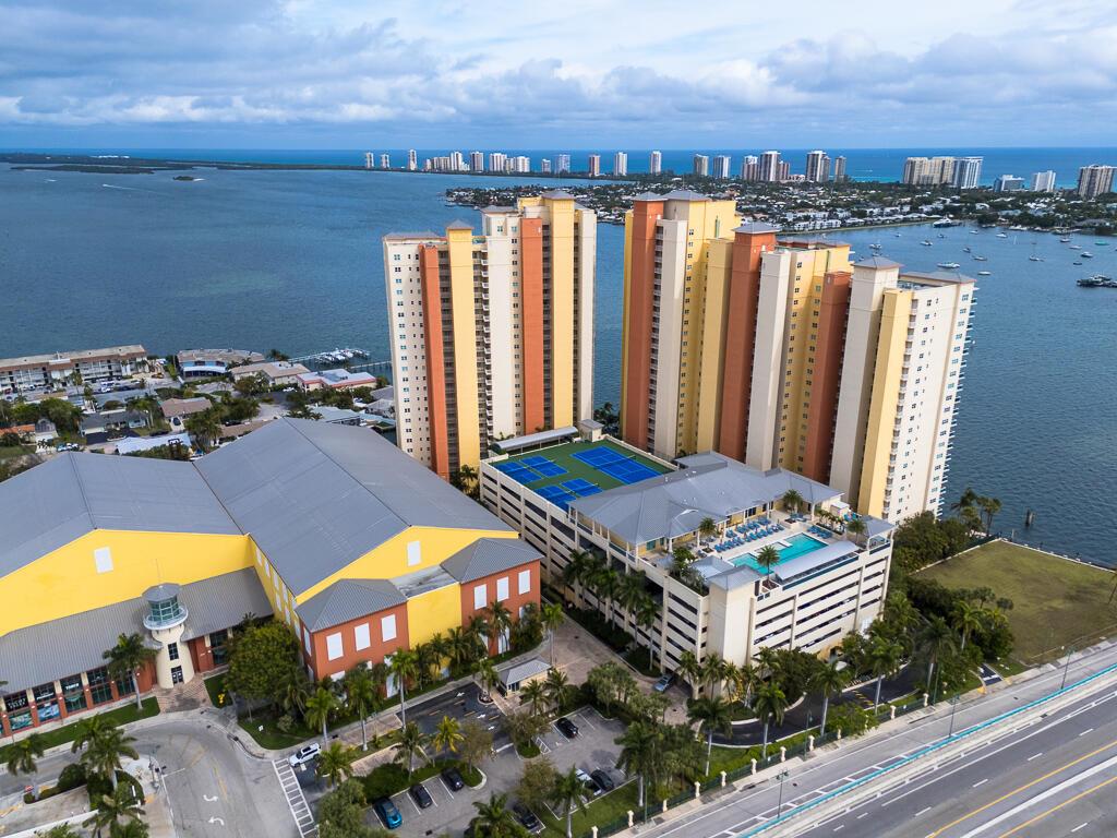 Welcome to Marina Grande - a 24-hour manned, gated community where luxury and comfort meet in this exquisite 3-bedroom, 3-bathroom home, offering 1,710 sq ft of beautifully designed living space.  Step inside to find panoramic 12th-floor views from the moment you walk in. The updated interior features neutral colors, tile flooring, and recessed lighting. The remodeled kitchen is a chef's delight, boasting quartz countertops, wood cabinetry, under-cabinet lighting, and all-new appliances, including a cooktop and custom vent hood. Convenience is key with in-unit laundry, complete with a brand-new stacked LG washer and dryer. Enjoy your morning coffee on the balcony, which offers stunning wide open ocean and Intracoastal views.  Marina Grande also provides a wealth of amenities including cable, Wi-Fi, and water in the HOA fees. Indulge in resort-style living with a pool, spa, tennis courts, pickleball, a fitness center, billiards, steam room, sauna, BBQ area, game room, and more. The community also features a manned gate, valet parking, security, extra storage, and is conveniently close to Loggerhead marina with indoor and outdoor boat storage options.  Explore the surrounding areas including a dog friendly Phil Foster park, Peanut Island, PGA golf courses and much more.  Don't miss this incredible opportunity to call Marina Grande home!