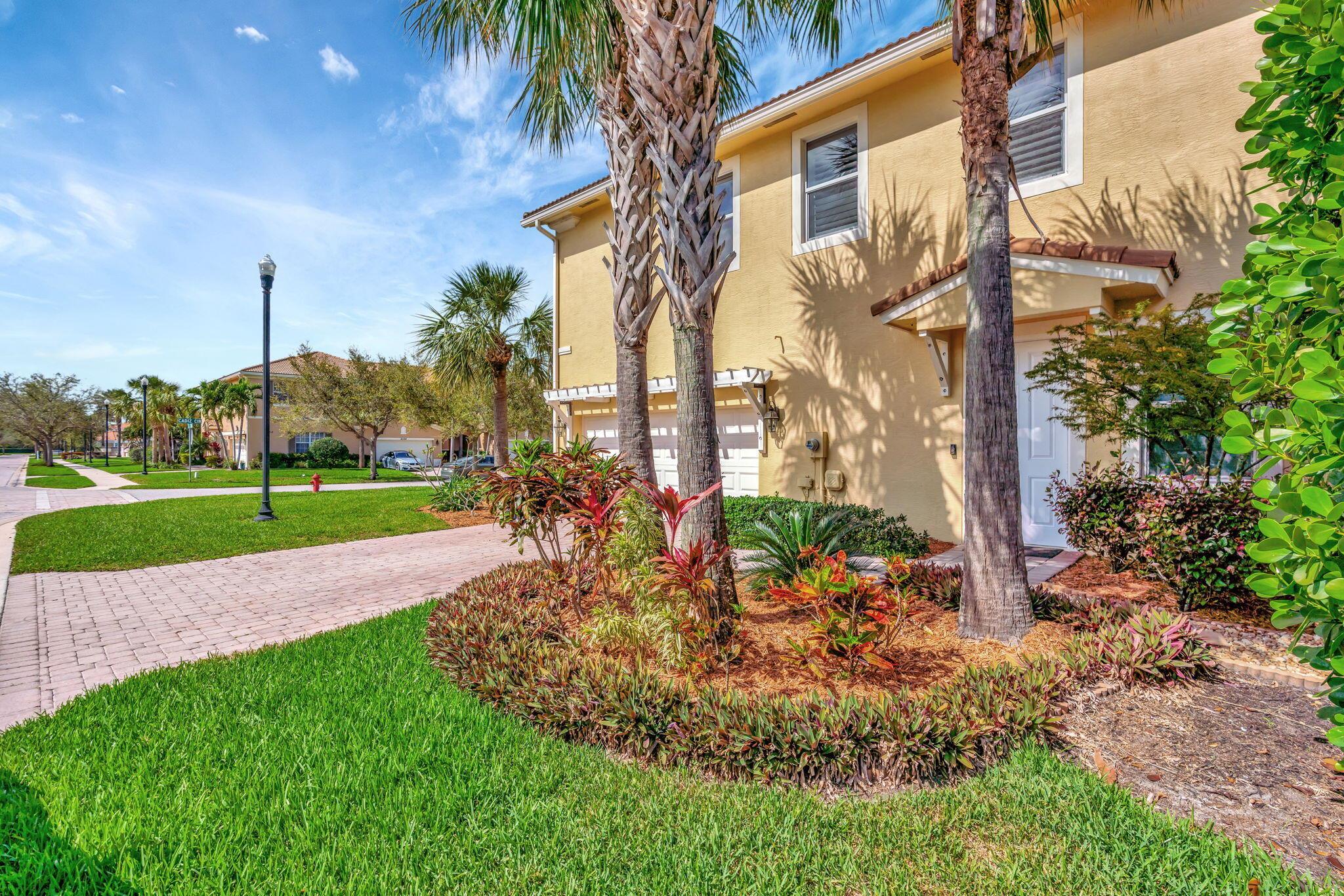 This stunning corner-lot TH in Paloma offers an abundance of natural light & a private outdoor retreat! This beautifully maintained 3-BR 2.5BA home has durable CBS construction and impact windows and doors. Recent upgrades include a brand-new GE range & refrigerator (2024), a new A/C unit (2022), a fenced-in yard, a screened lanai & The open floor plan features tile flooring downstairs & wood flooring throughout the upstairs & primary suite. The spacious primary suite boasts a walk-in closet, dual vanities, a walk-in shower with a frameless glass door, & a garden tub. Plantation shutters adorn the great room & loft, & 2-car garage inc built-in storage cabinets. Situated on a cul-de-sac, this end unit offers privacy with a hedge-lined, fenced backyard. Perfect for South Florida living!