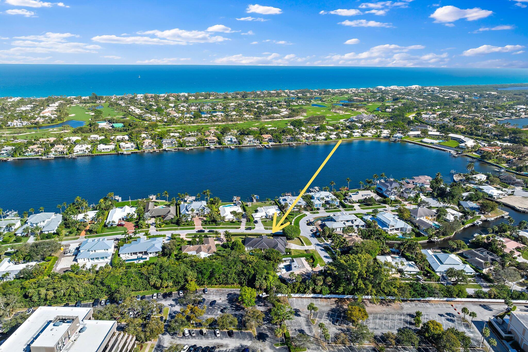 EXQUISITE modern coastal home, built in 2017, exemplifies the highest quality construction + classic Florida design. Nestled in Hidden Key, a gated enclave East of US 1, this residence offers the perfect blend of luxury, durability + timeless elegance. Set on a 1/2 Acre corner lot, the property backs up to a small canal w/ boating options. Lush surrounding greenery + tropical plantings create a picturesque setting + private retreat. Designed for seamless indoor to outdoor living, the one-level residence features rich wood flooring throughout, complemented by Visual Comfort lighting for a warm, inviting ambiance. Seamless vaulted ceilings add a bright finishing touch while Expansive Anderson 'A-Series' Impact windows enhance the space with natural light while providing superior protection. The heart of the home is the Chef's dream kitchen, equipped with top of the line Wolf + Sub Zero appliances, custom Crown Point cabinets and sleek quartz countertops. The walk in pantry offers tons of storage.  A cozy family room + grand media room/den provide additional gathering space.  The elegant + private Owner's suite is a true sanctuary, boasting grand space, a spa like bath and two generous walk in closets.  There are 3 large + luxurious guest rooms in the South wing of the home, offering privacy + serenity and easy outdoor access.  The laundry room features double washers + dryers and great work space.  The garage is designed for the automobile enthusiast, featuring a lift for additional vehicle and an electric charging station.  Additional features include a full house water filtration system, InstaHot water system, a Kohler generator and automatic 'phantom screens' on the lanai.   The outdoor living space is impeccable, beginning with an 8' deep saline pool.  The surrounding area features a custom stone patio + huge yard graced by enchanting greenery.  An enclosed outdoor shower adds to the resort feel.  This home offers the Finest in Florida living, from the highest end construction (9+' elevation) to thoughtfully curated design elements throughout.  You feel the elevated quality the moment you set foot in this home!  All set in one of the Palm Beaches most coveted areas, minutes from world class beaches, golf, shopping, dining, educational and cultural venues.  The newly renovated North Palm Beach Country Club (open to public) is just down the road, offering Signature Jack Nicklaus golf, tennis, Olympic Pool + fine or casual dining... Truly a fabulous place to live!