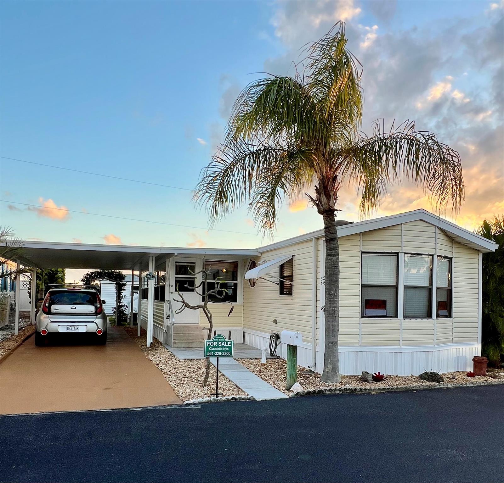 Welcome to paradise!  This updated 2 bedroom, 2 bath manufactured home is on a premium lot with a preserve view out back.  New roof and newer wood floors, a covered porch with queen futon and a/c plus a new outdoor deck make Florida living easy.  This community is steps from the beautiful beaches of Jupiter and Juno and close to restaurants and shopping.  The neighborhood is quiet and peaceful.  The best part is you own the land!  Come see this beauty today-it will not last long!  Kayaks, fishing gear and pots and pans do not convey.