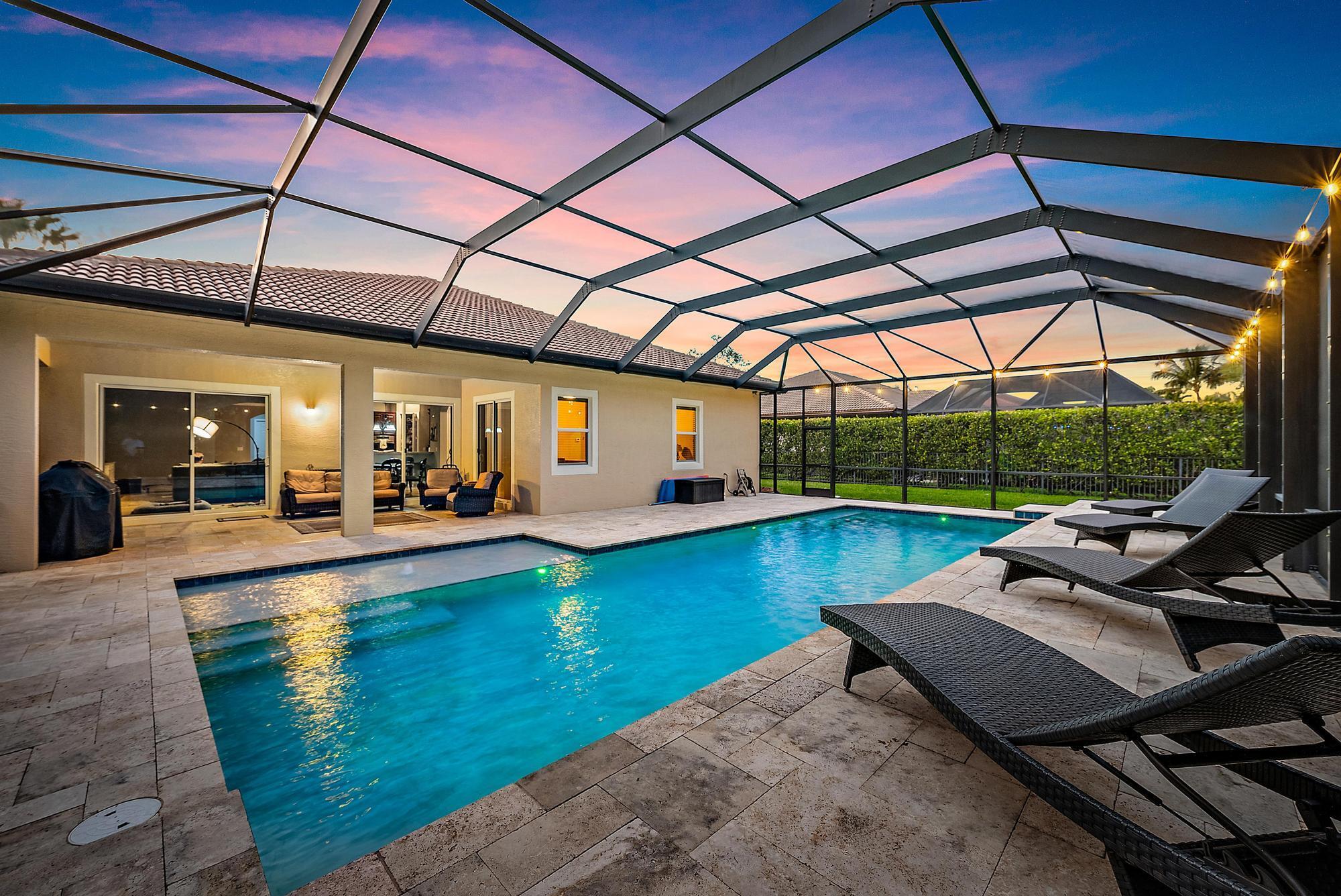 This exquisite Monterra model home is situated in the gated, family-friendly community of Rialto. Set on an oversized lot, this four-bedroom, three-bathroom residence spans a generous 2,854 square feet under air. Upon entering, you are welcomed by a bright and open space with diagonal tile floors in the main living areas, elegant coffered ceilings, an arched entryway, and thick crown molding and trim. Just beyond the foyer, the living and dining areas provide a warm and inviting ambiance. The kitchen, open to the family room and breakfast nook, offers ample counter and cabinet space, featuring granite countertops, stainless steel appliances, a double wall oven, an electric cooktop stove, and a walk-in pantry. Additional highlights include a refrigerator less than a year old, a newer dishwasher, a reverse osmosis system, and cabinets with pull-out shelving for added convenience.

The spacious master suite boasts coffered ceilings, hand-scraped wood flooring, a custom walk-in closet, and a luxurious en-suite bath with a frameless glass shower, dual sinks, and a Roman tub. The guest bedrooms also feature rich wood flooring, ensuring comfort and style throughout. Notable updates include a freshly painted interior, new door rollers, UV lighting in the AC, newer washer and dryer, and impact-resistant windows for enhanced hurricane protection.

Step outside to a private covered lanai with Travertine marble decking, leading to a screened-in, heated saltwater pool with a new variable-speed pump installed in October 2024. Lush tropical landscaping surrounds the outdoor space, creating a serene retreat for relaxation and entertainment.

Rialto is a premier gated community with access to A-rated schools and a beautiful nature preserve. The HOA maintains both the front and back lawns as part of the dues, allowing for a low-maintenance lifestyle. Residents enjoy an impressive clubhouse with a fitness center, a children's splash park, a resort-style pool and jacuzzi, multiple playgrounds, basketball courts, two tennis courts, and scenic walking and jogging trails. The active social committee regularly organizes events for all ages. Just across the street, Jupiter Community Park offers a variety of sports programs for both kids and adults.

Ideally located in the heart of Jupiter, this home is just minutes from stunning beaches, fine dining, and upscale shopping. Convenient highway access via I-95 and the Turnpike makes travel easy, with Palm Beach International Airport only a short drive away.