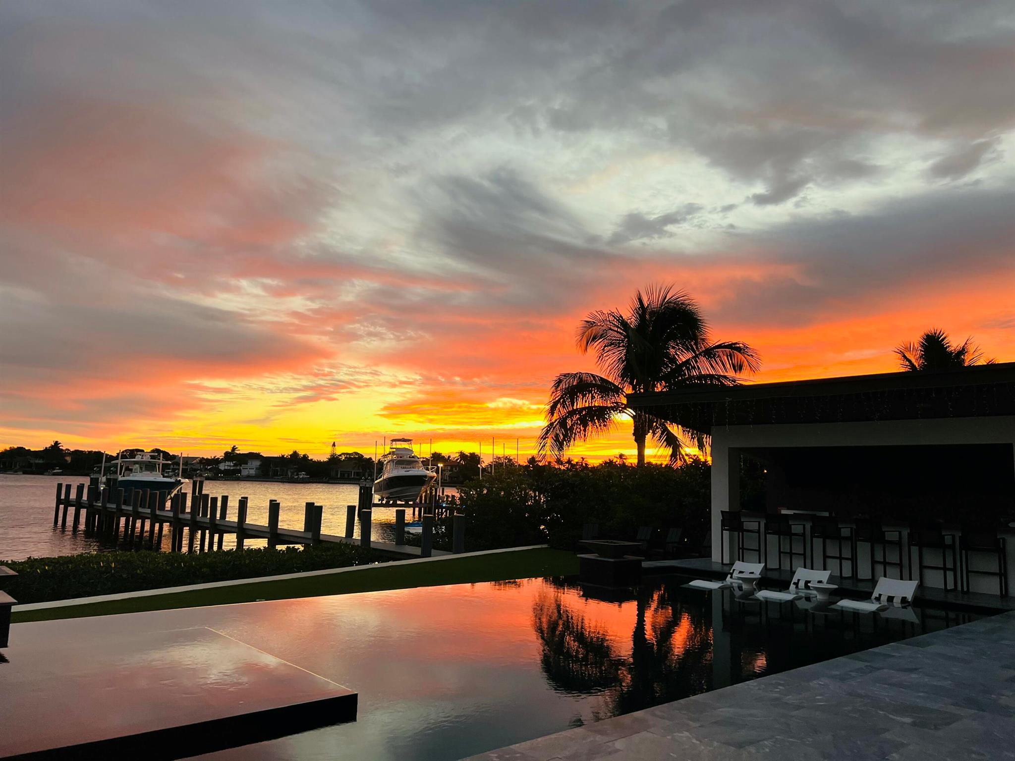 Welcome Home! Nestled in the heart of Jupiter. Newly built waterfront estate is a rare gem. Offering unparalleled luxury, breathtaking views, and the ultimate South Florida lifestyle. Perfectly positioned on a cul-de-sac along the wide Loxahatchee River. This extraordinary residence boasts picturesque views of sunrises and serene waters. Spanning almost 7,000 square feet of living space in the main residence is designed to impress, featuring 5 ensuite bedrooms 5.5 baths. A separate guest house is currently under construction offering 2 additional bedrooms and 1 full bathroom. The expansive open concept living spaces are adorned with soaring designer finishes.The gourmet chef's kitchen is a culinary dream, outfitted with top-of-the-line Thermador appliances, custom cabinetry, with two kitchen islands, beverage fridges. It is designed for culinary enthusiasts and perfect for entertaining. Step outside into a resort-style oasis designed for both relaxation and entertainment. The infinity-edge pool, adorned with fire bowls creates a stunning focal point. Unwind in the hot tub, gather around and take in the spectacular views of the waterway. The summer kitchen, gazebo bar with waterfall feature and outdoor lounge area provides the perfect setting for hosting unforgettable gatherings. With your own private, built-out dock with a 50,000 lb boatlift and no fixed bridges, this property is a boater's dream, offering quick and easy access to the Jupiter Inlet, nearby sandbars, and the Atlantic Ocean. Whether you're an avid fisherman or simply enjoy cruising the waterways, this location is second to none. 9 Bamboo is more than just a home it's a lifestyle. Situated in Jupiter. One of the most sought-after locations. This estate offers the perfect blend of exclusivity and accessibility. Enjoy world-class golf courses, fine dining, luxury shopping, and top-rated schools, all just minutes away. With quick access to I-95, Florida's Turnpike, and both public and private airports, travel is effortless, making this home ideal for those seeking both privacy and convenience. Indulge in the finest of waterfront living schedule your private tour today! 

All information is deemed reliable. Measurements are approximate. Buyer responsible to verify information directly.