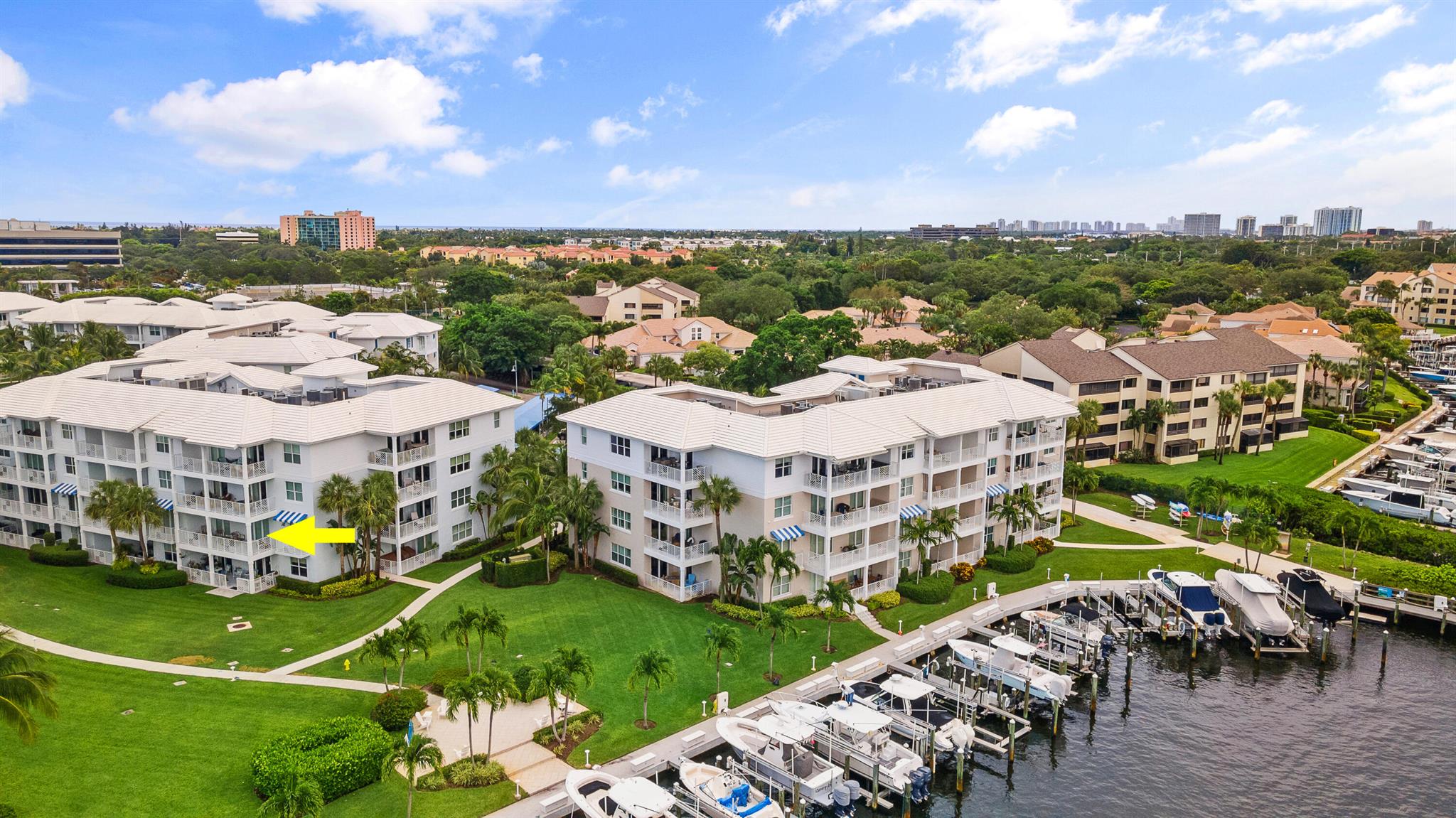 Experience luxury waterfront living with stunning Intracoastal views from every window in this updated 2nd-floor condo. This bright, spacious home features private balconies, perfect for enjoying serene water views. The renovated kitchen features stainless steel appliances, Cristallo quartzite countertops, white wood cabinetry, a walk-in pantry, dine-in bar seating, & a bar area. New flooring flows throughout the main living areas & bedrooms. Lavish bathrooms include granite countertops & glass-enclosed showers. Additional features: impact glass, secure entry, extra storage, & a 2024 A/C.Resort-style amenities, including a private marina, pool, spa, tennis courts, & clubhouse.A premier deeded 51' x 19' boat slip with a new 50,000 lb lift is included. Located in a no-wake zone.