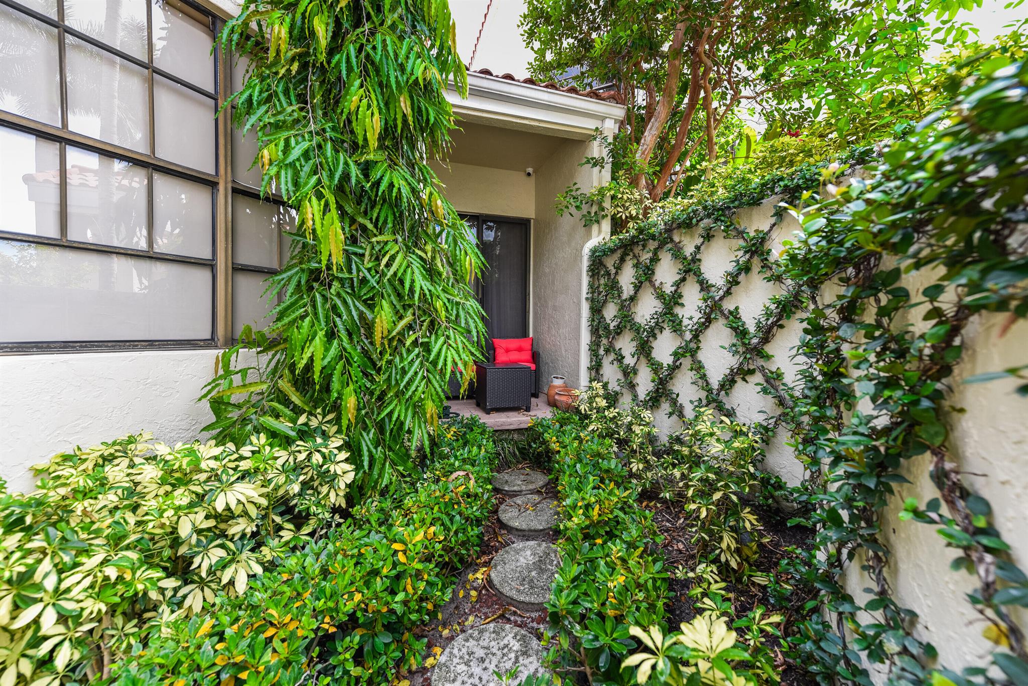 Discover this charming two-bedroom, two bathroom upgraded & professionally designed villa, situated on the 9th hole of the award-winning Fazio-designed 18-hole golf course. This villa boasts a light, bright, & airy decor, featuring a beautiful tropical garden & spa view. A cozy office/den area, a large master bedroom with an expansive closet, & tastefully elegant ensuite bathroom provide a touch of luxury. Within walking distance, you'll find the recently remodeled clubhouse, expansive fitness center, active tennis & pickleball courts, golf pro shop, driving range, children's playground, resort-style pool, savory poolside cafe, boutique shopping, trendy restaurants, & diverse places of worship. Embrace the secure & exclusive lifestyle you truly deserve. Call today for your private tour.